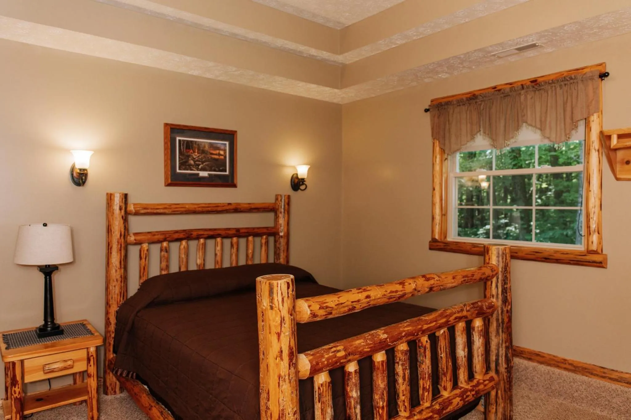 Bed in Sojourner's Lodge & Log Cabin Suites