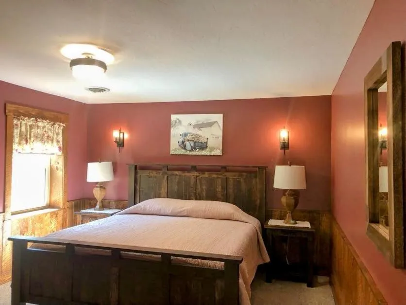 Bed in Sojourner's Lodge & Log Cabin Suites