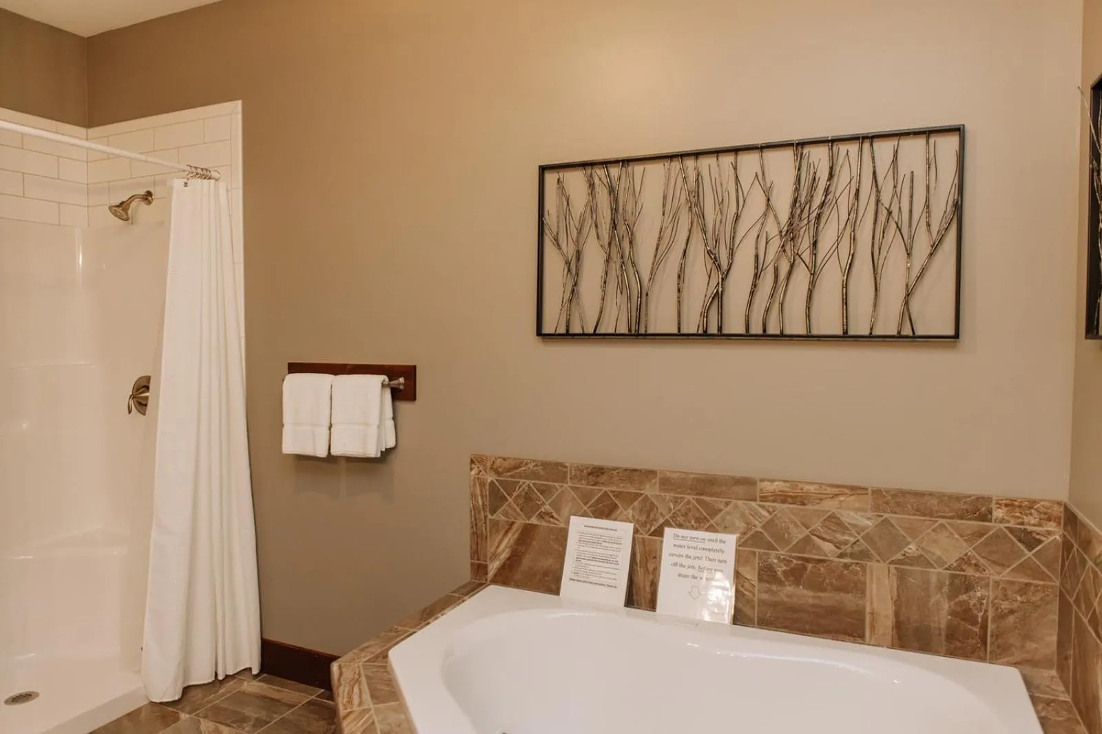 Bed in Sojourner's Lodge & Log Cabin Suites