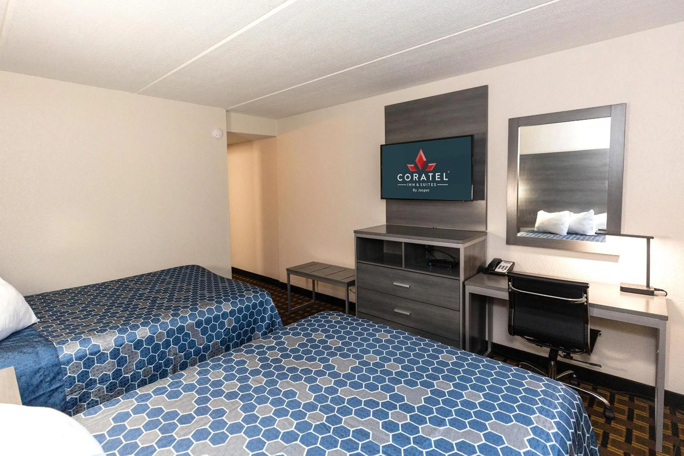 Communal lounge/ TV room, Bed in Coratel Inn & Suites by Jasper Mankato