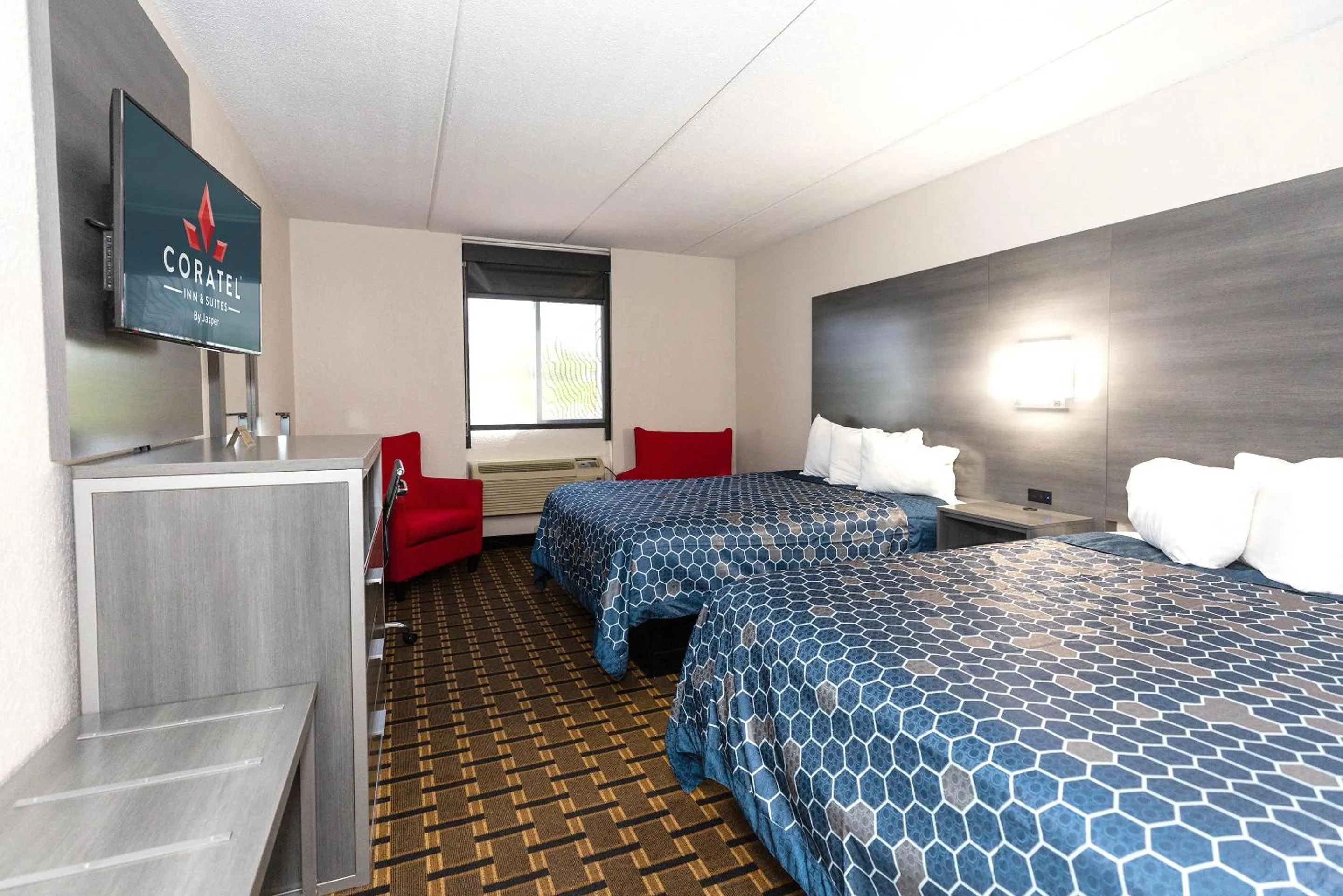 Bed in Coratel Inn & Suites by Jasper Mankato