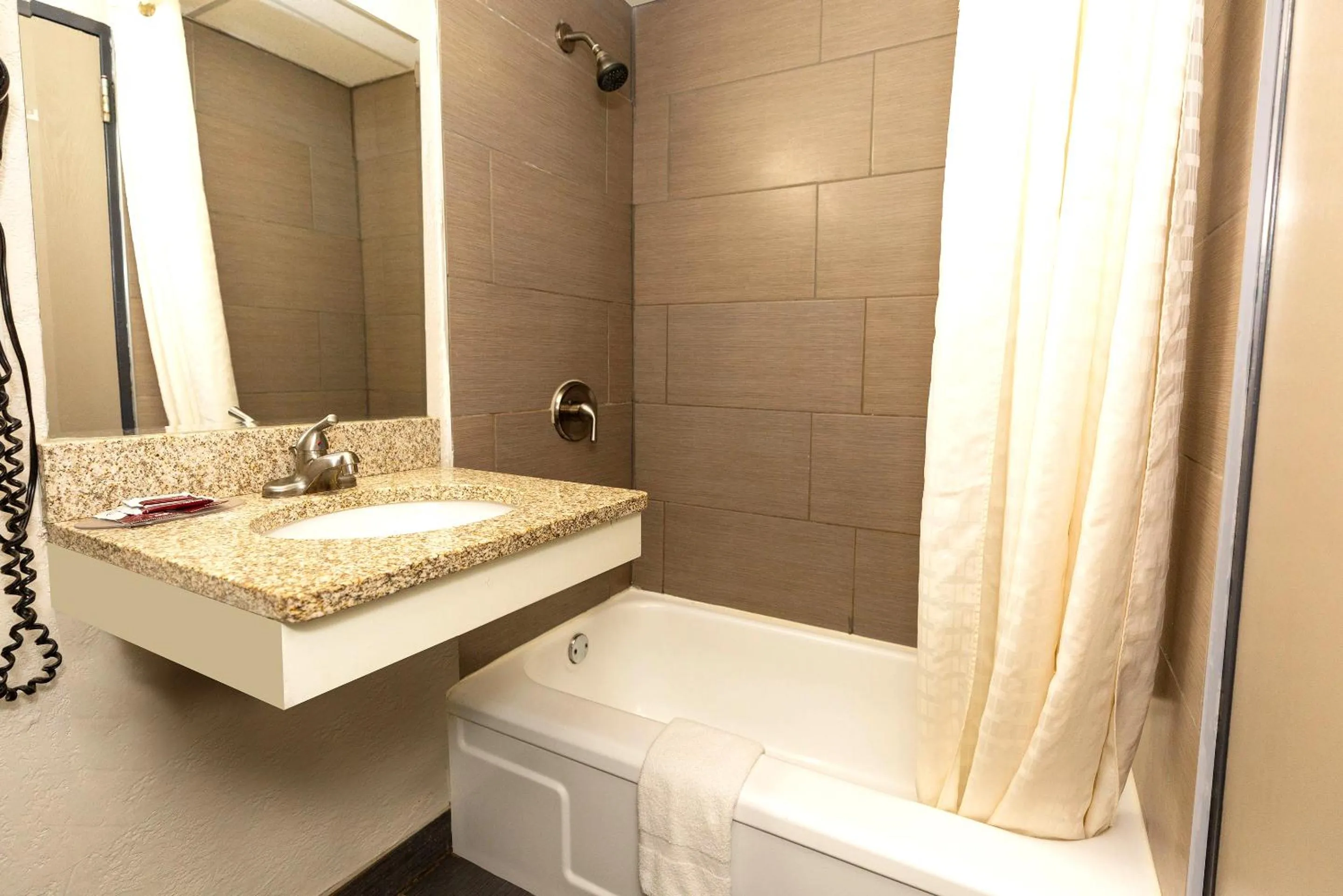 Shower in Coratel Inn & Suites by Jasper Mankato