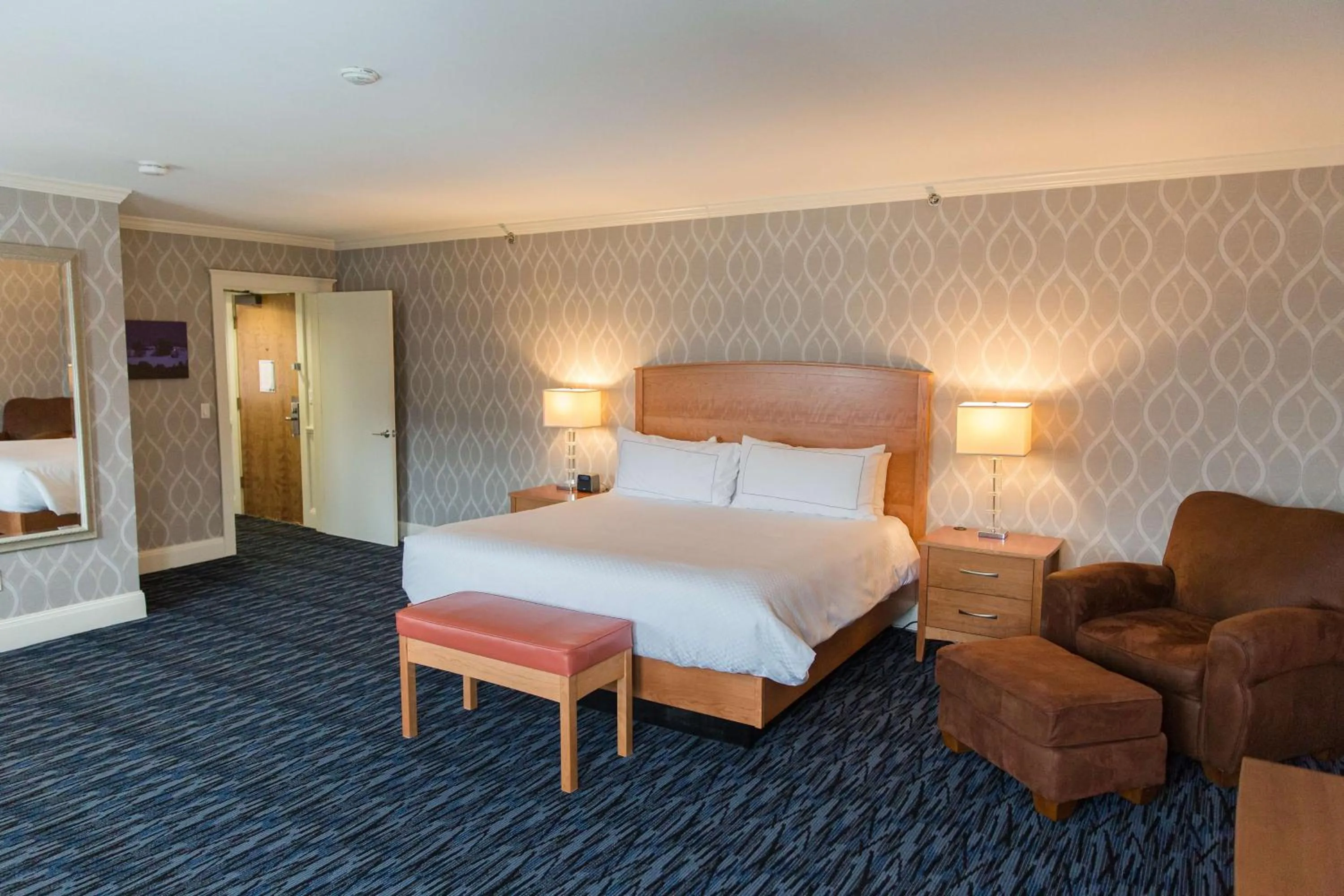 Living room, Bed in Capitol Plaza Hotel Montpelier Tapestry Collection by Hilton