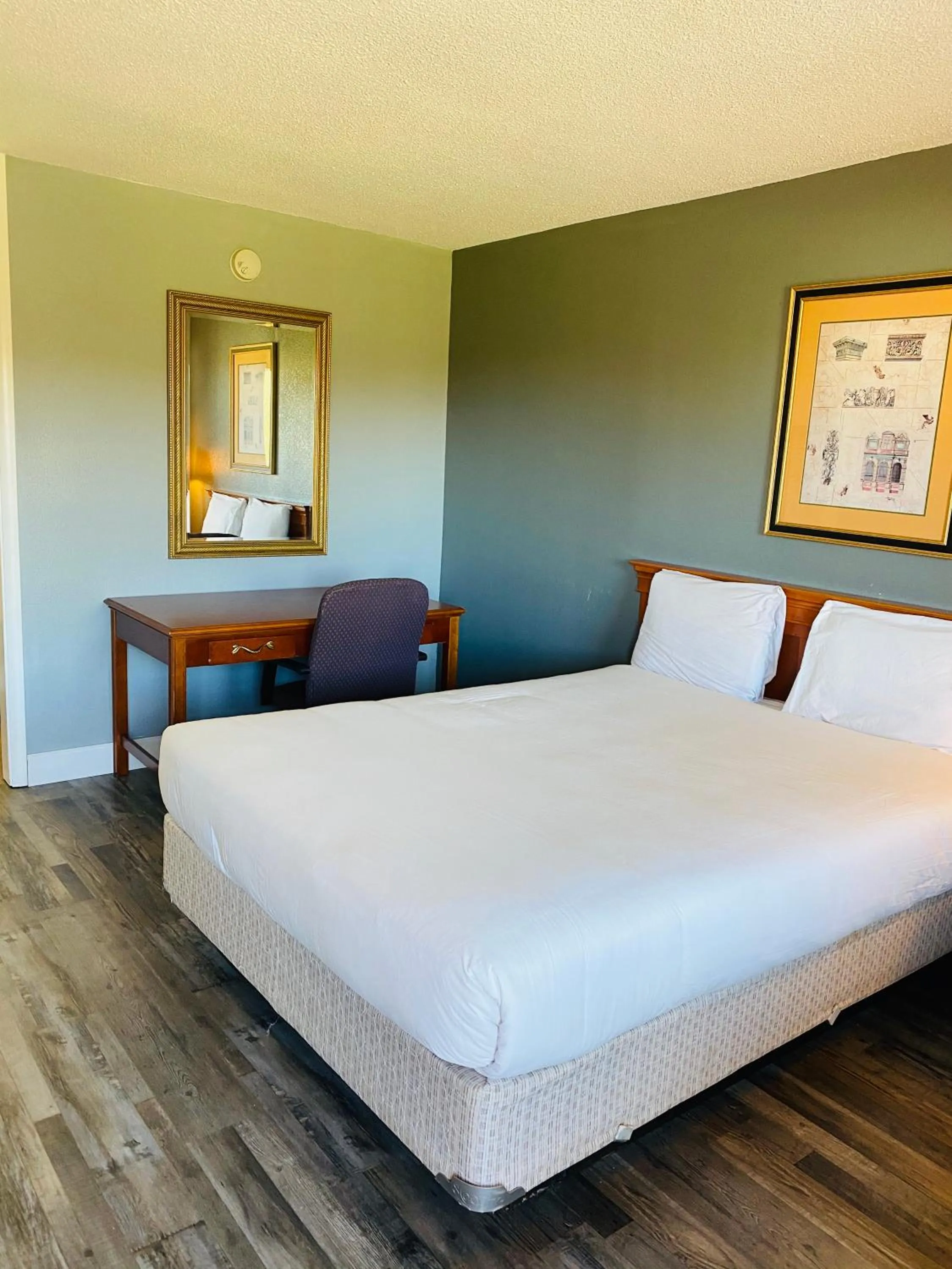 Bed in Traveler's Place Inn & Suites