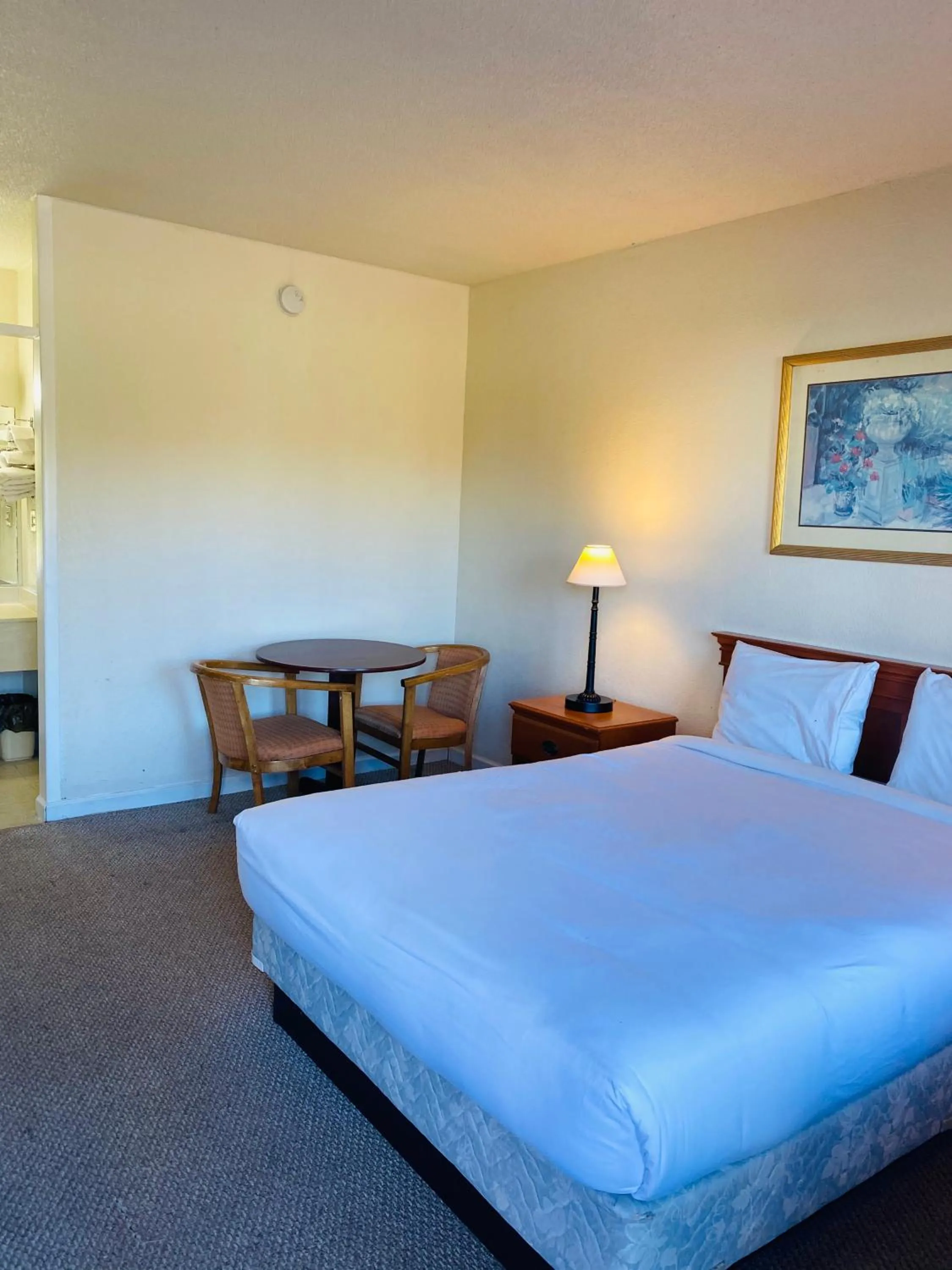 Bed in Traveler's Place Inn & Suites