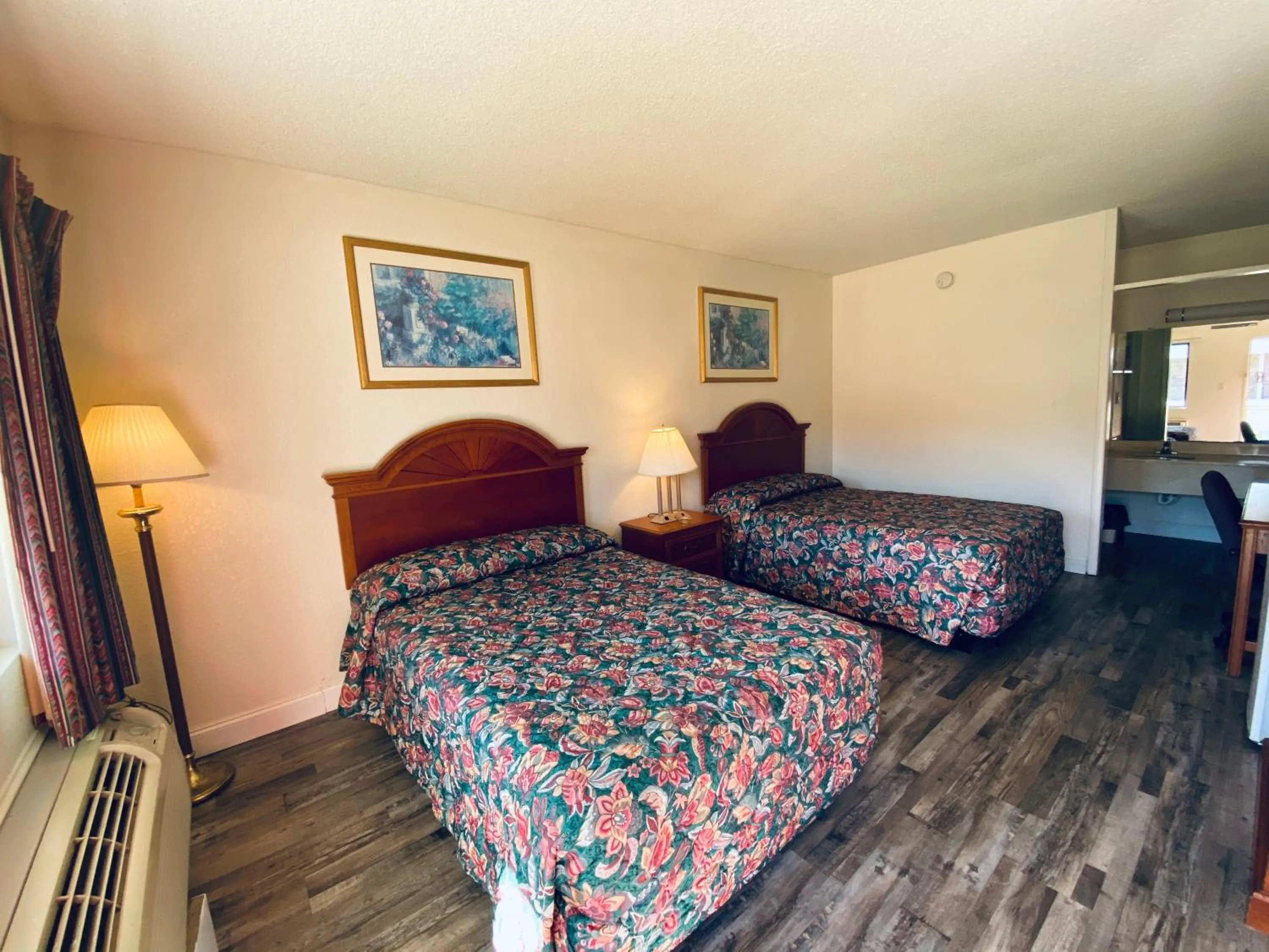 Bed in Traveler's Place Inn & Suites