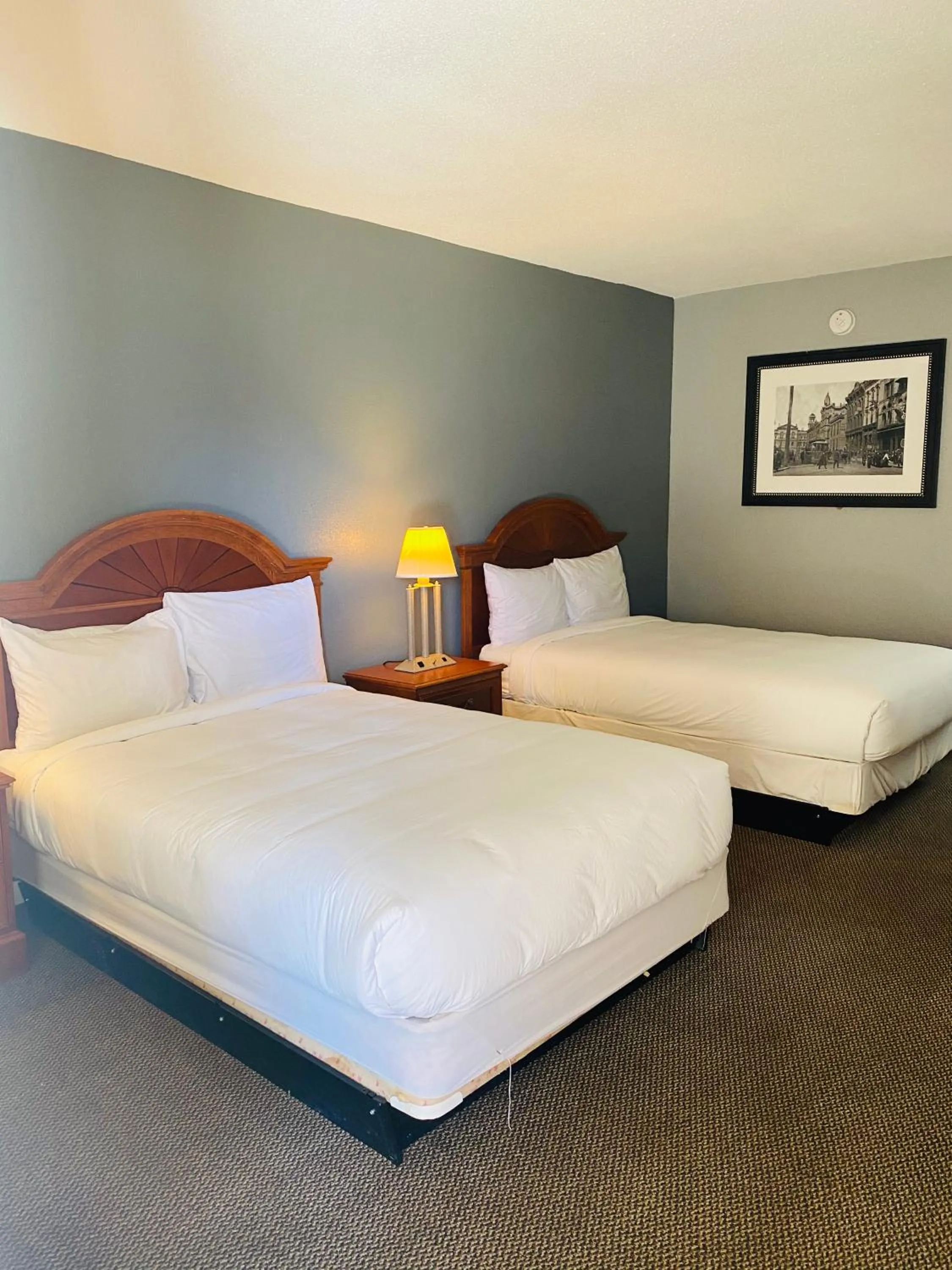 Bed in Traveler's Place Inn & Suites