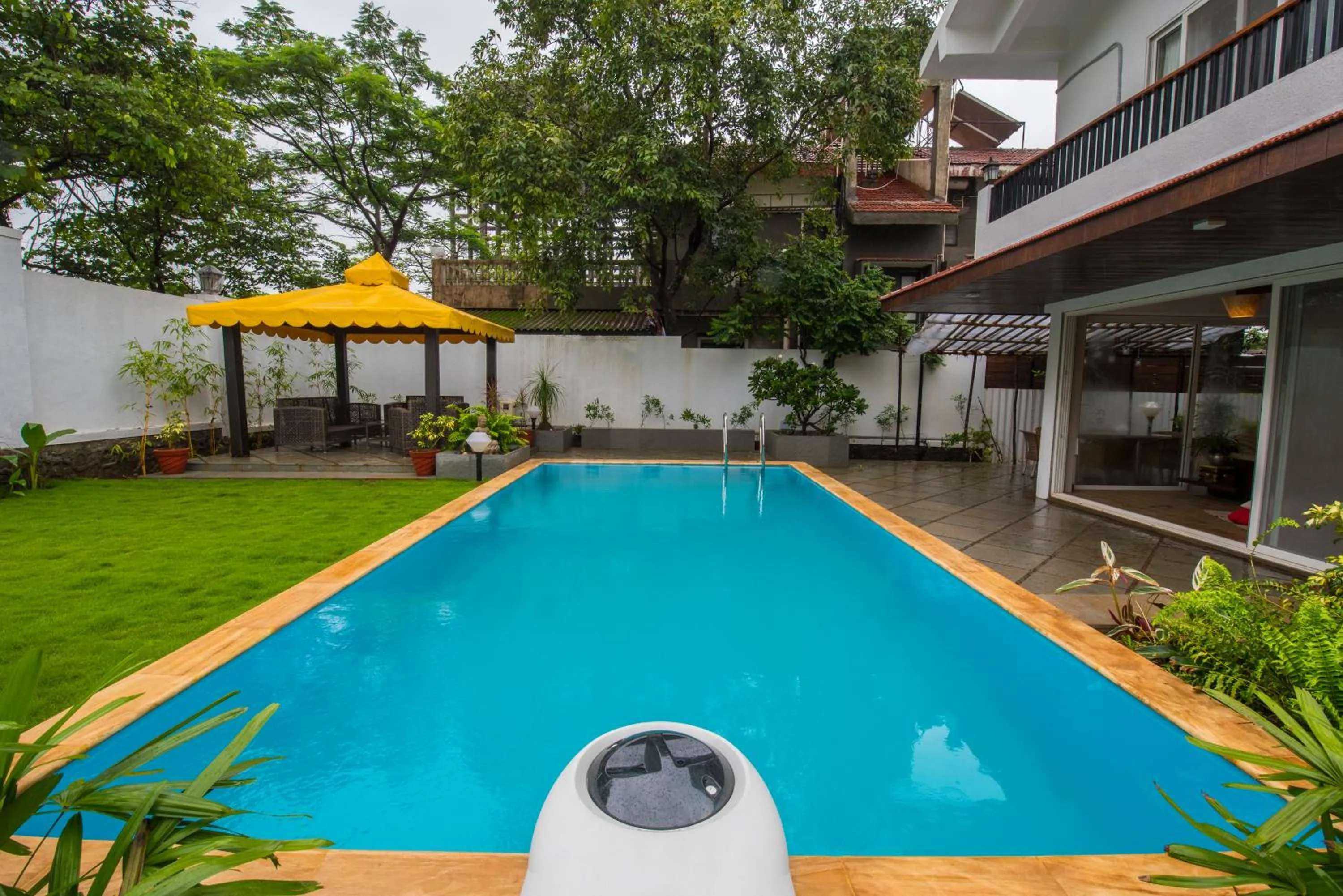 Swimming pool in EL Lodge by StayVista - Pool, lawn, and a charming gazebo for your perfect getaway