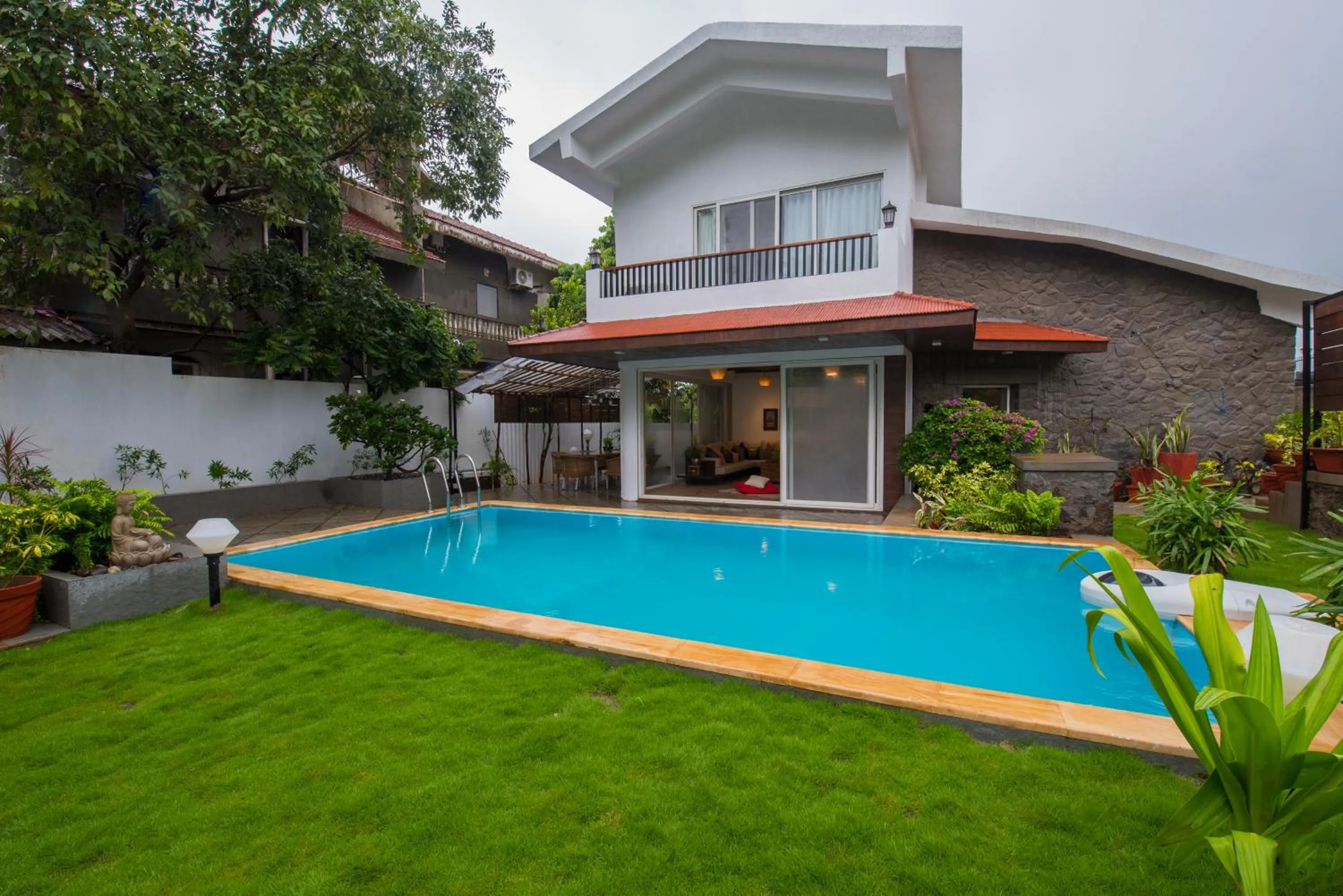 Swimming pool in EL Lodge by StayVista - Pool, lawn, and a charming gazebo for your perfect getaway