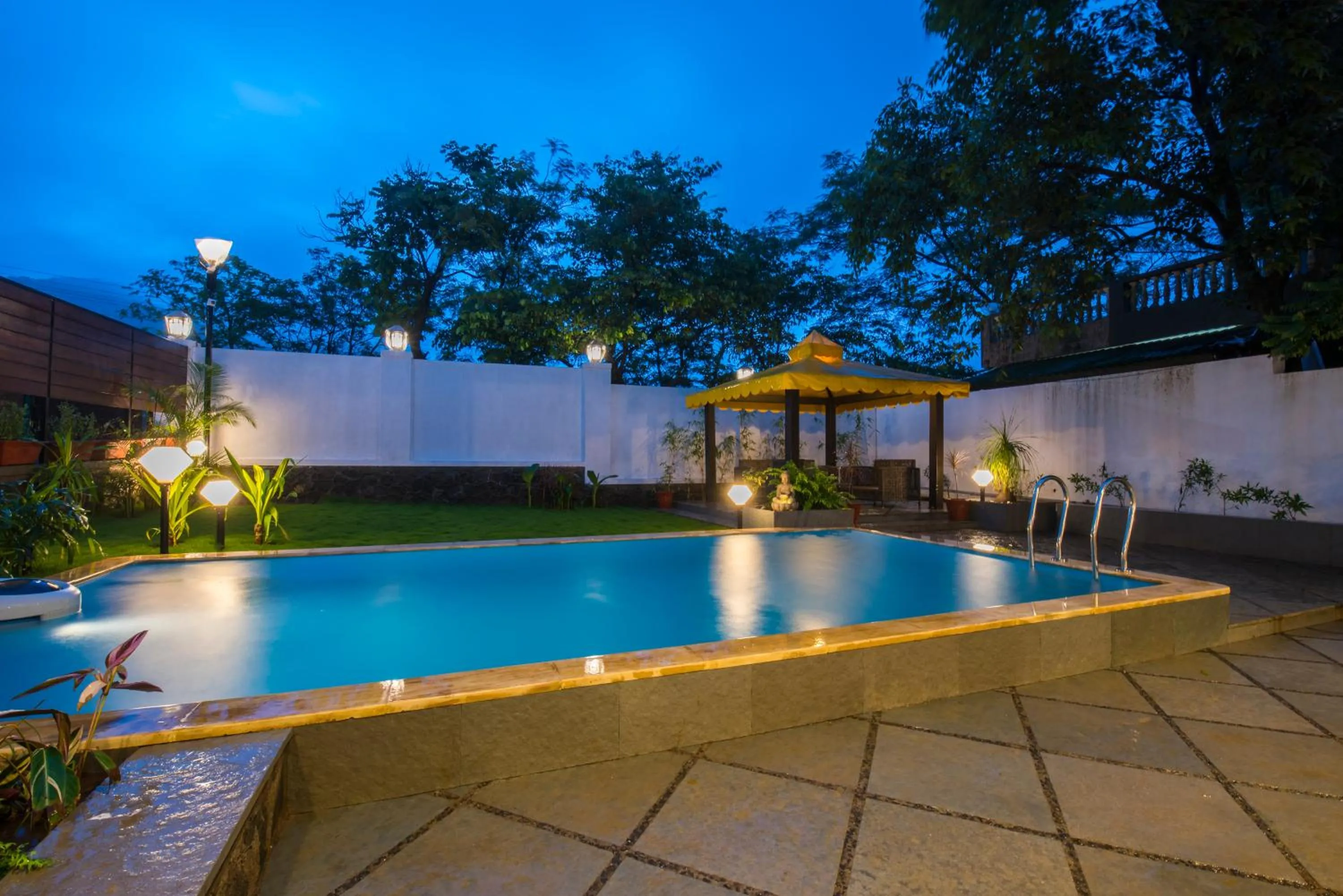 Swimming pool in EL Lodge by StayVista - Pool, lawn, and a charming gazebo for your perfect getaway