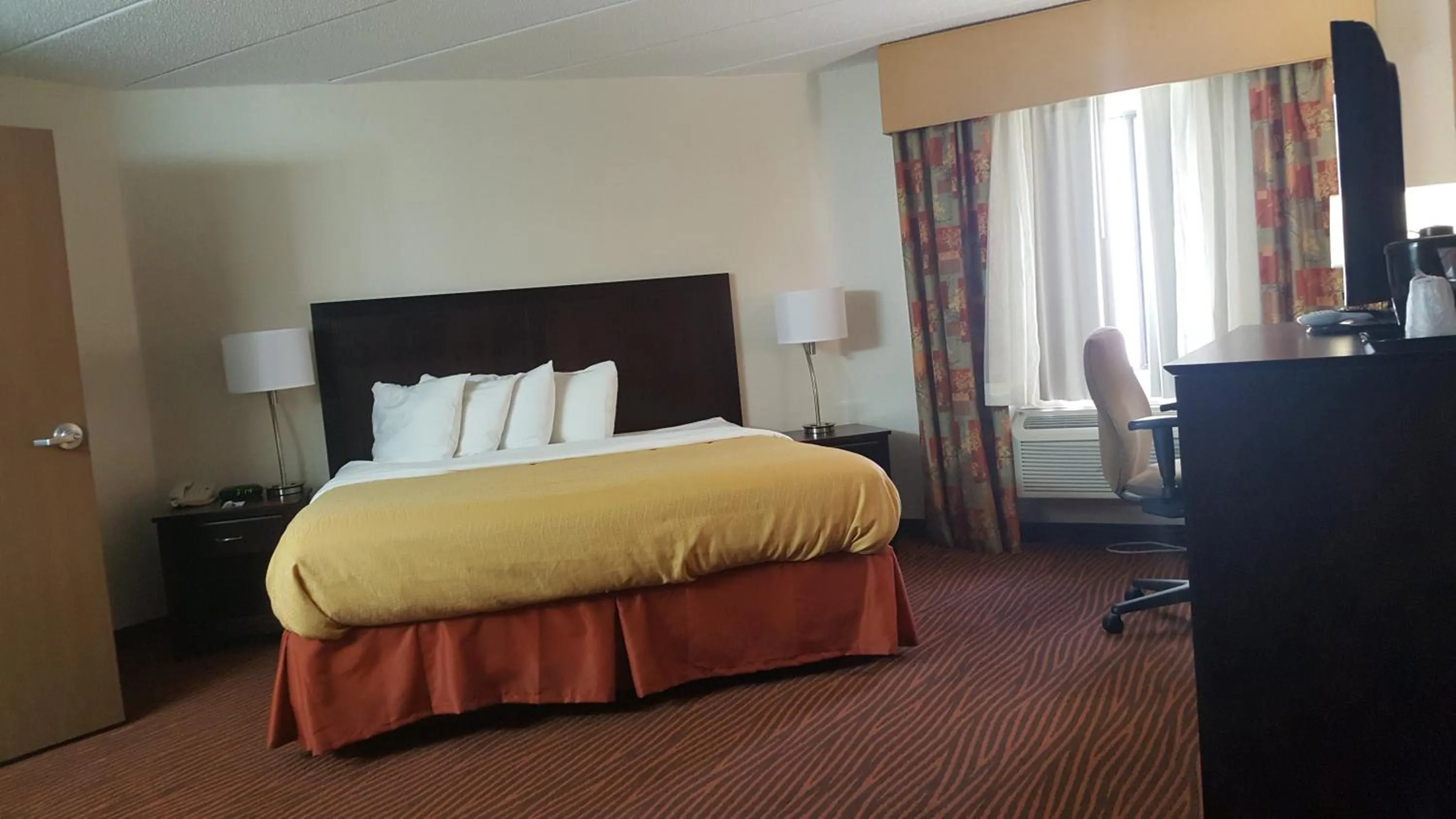 Bed in AmericInn by Wyndham Muscatine