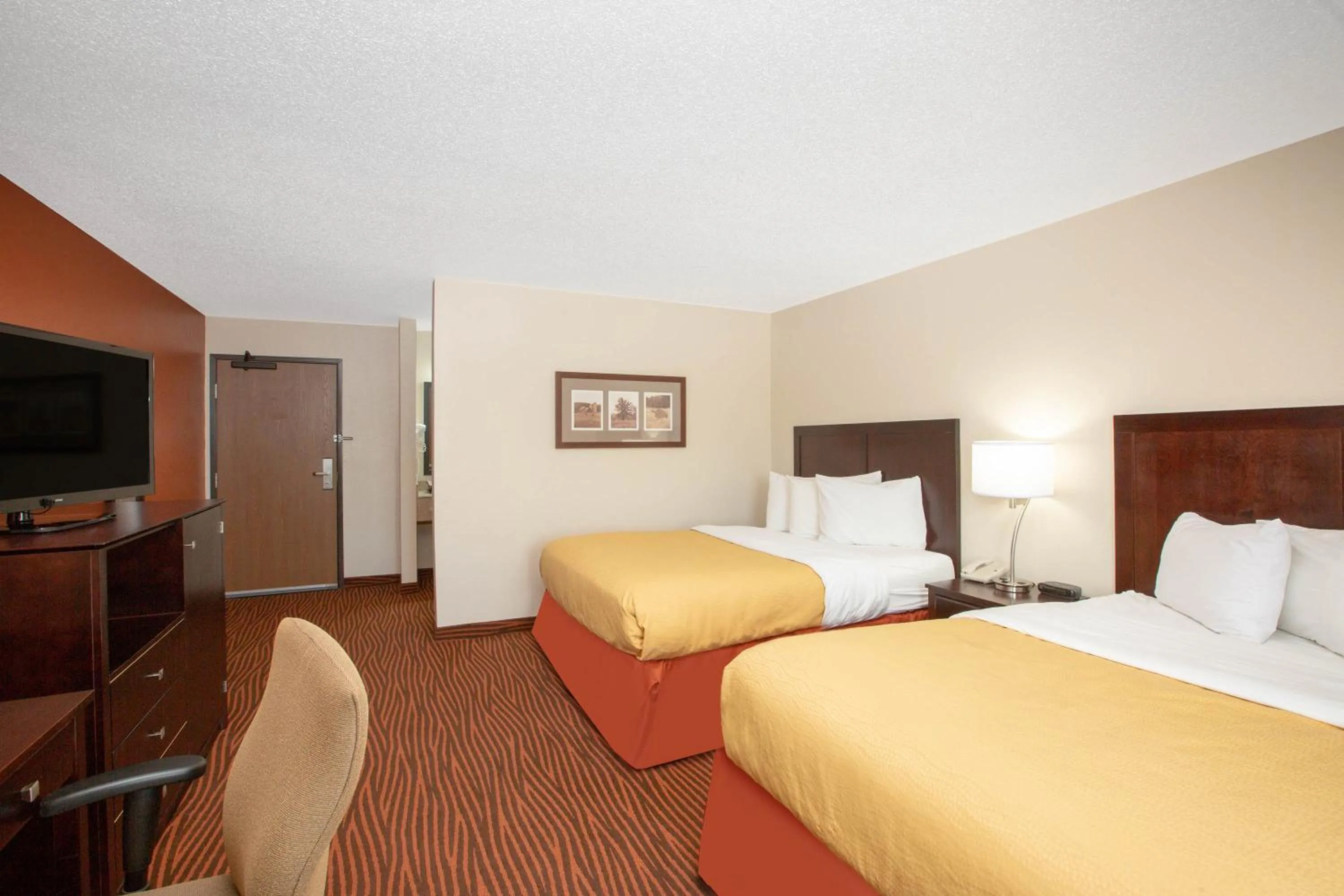 Bed in AmericInn by Wyndham Muscatine