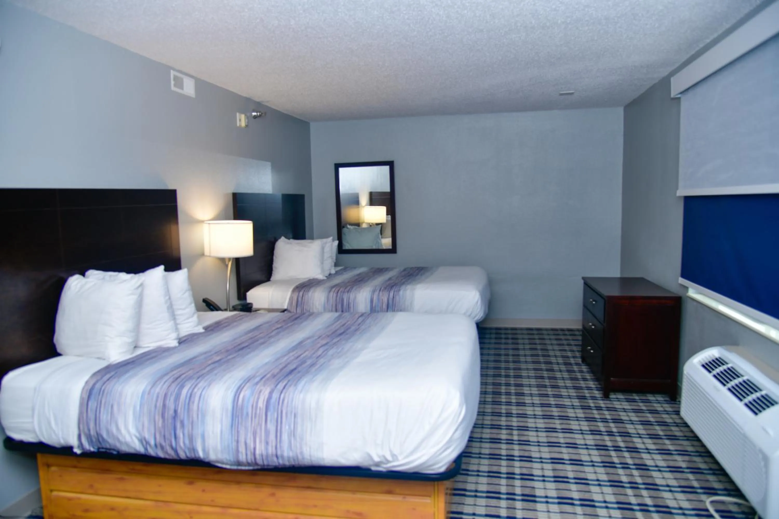 Bed in AmericInn by Wyndham Muscatine