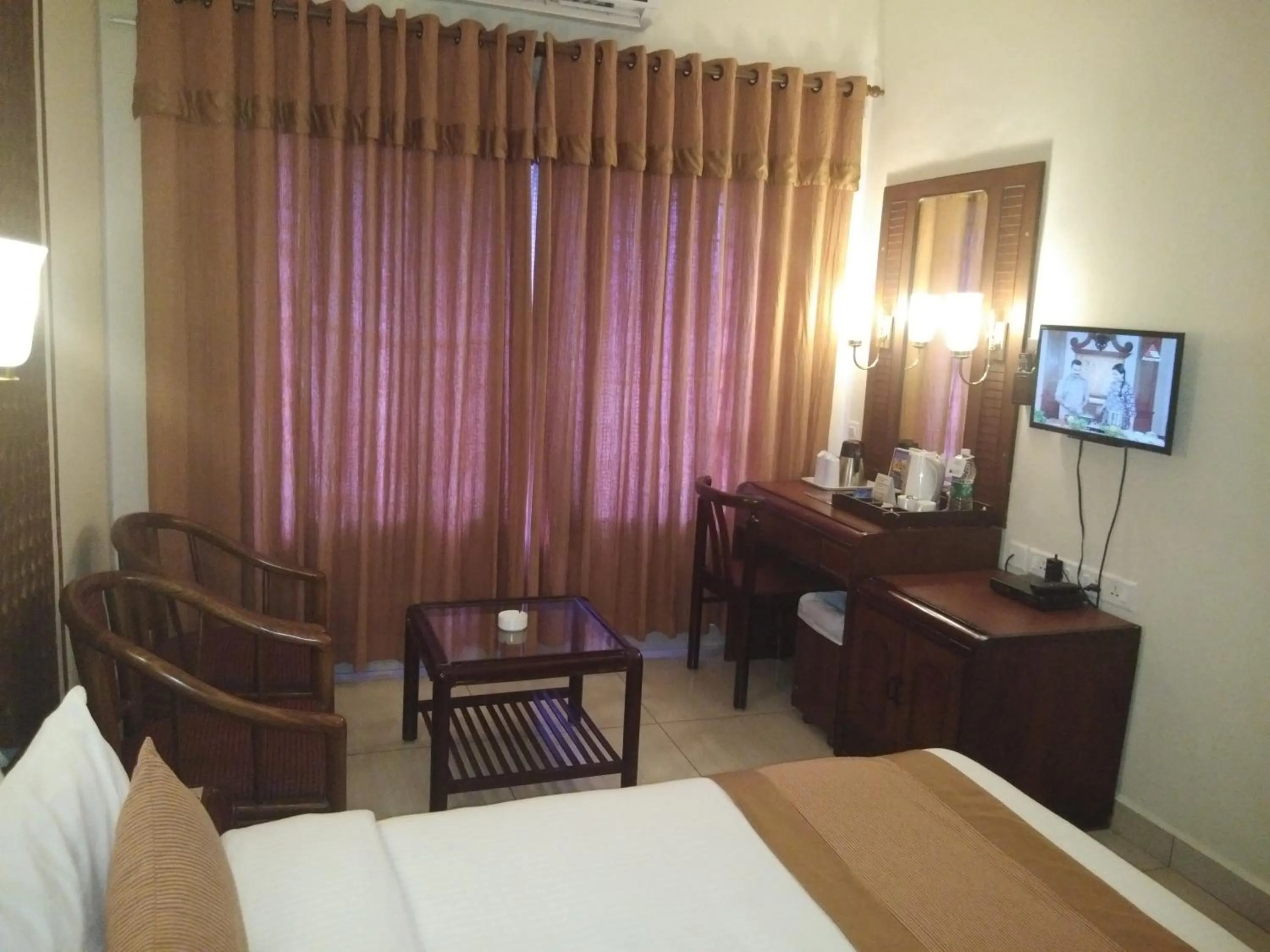 Seating area, Bed in Yuvarani Residency