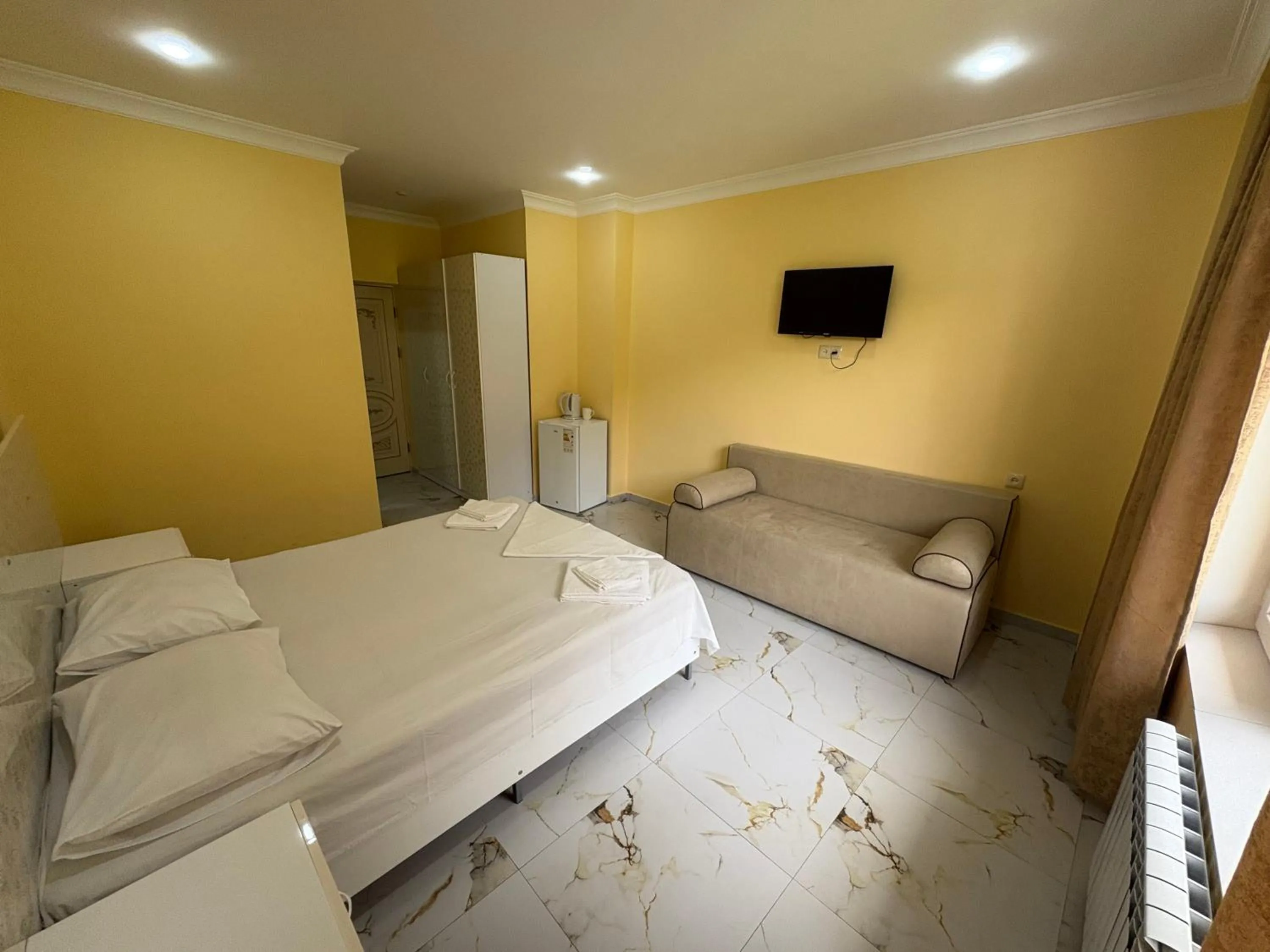 Communal lounge/ TV room, Bed in Red Hotel Yerevan Center