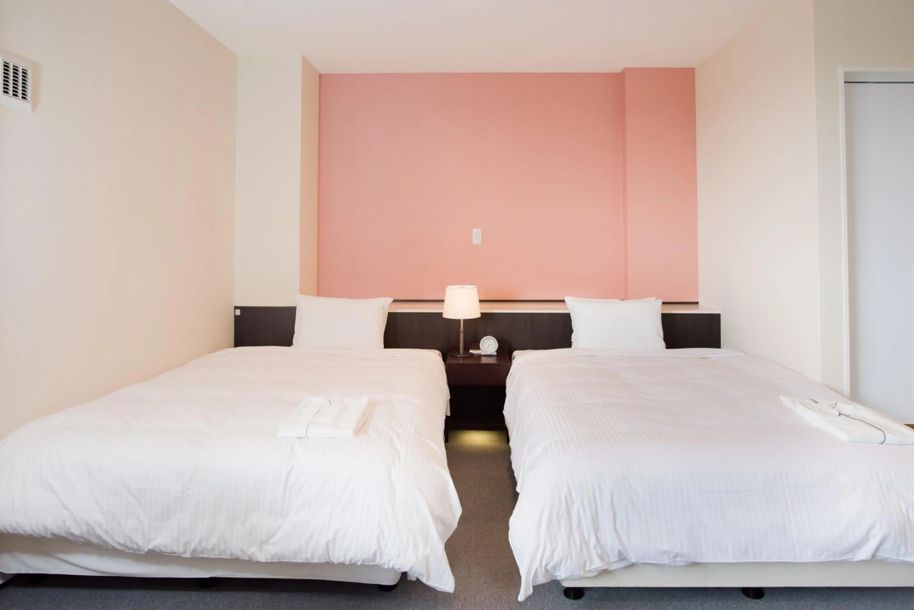 Bed in Crown Hotel Okinawa Annex