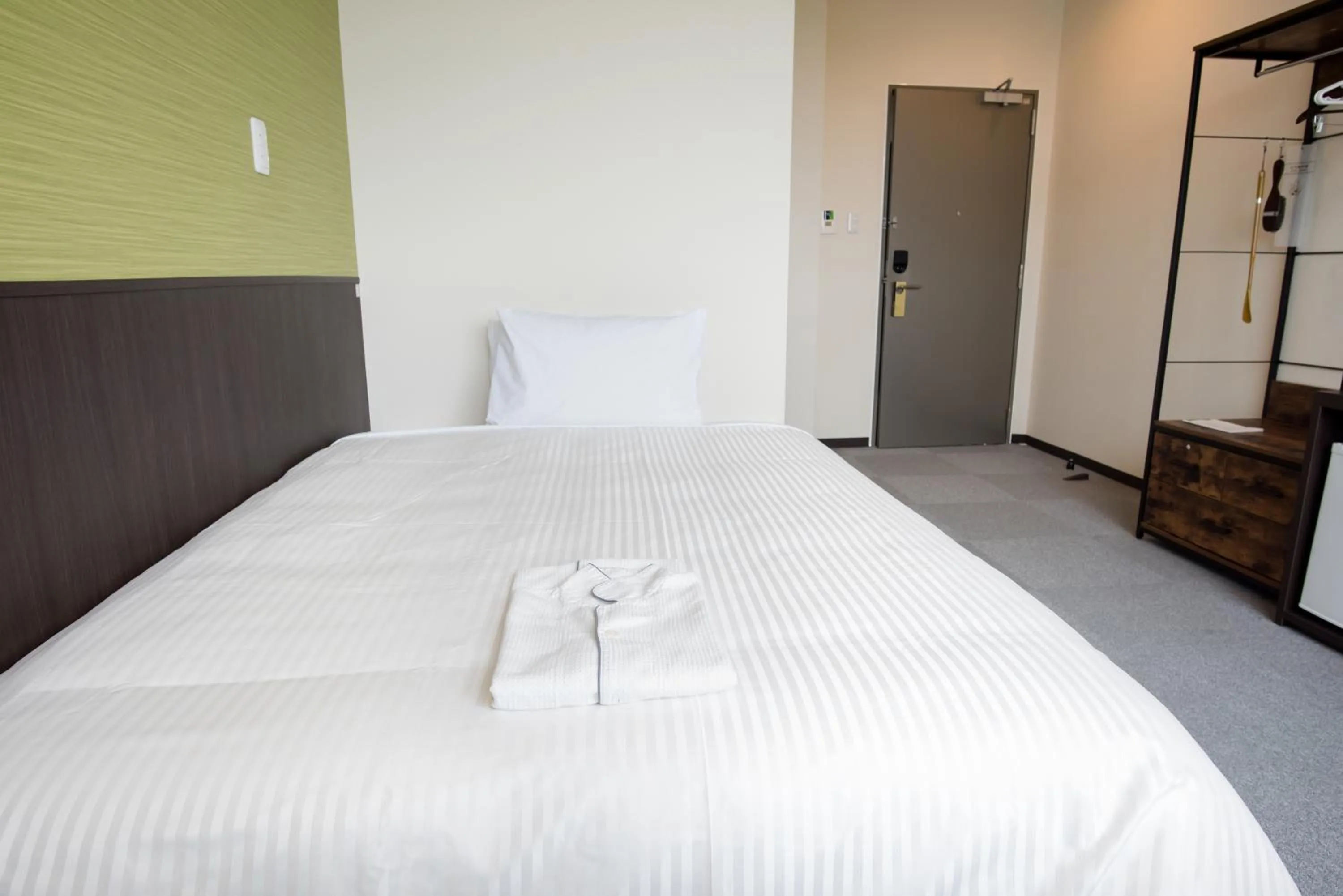 Bed in Crown Hotel Okinawa Annex