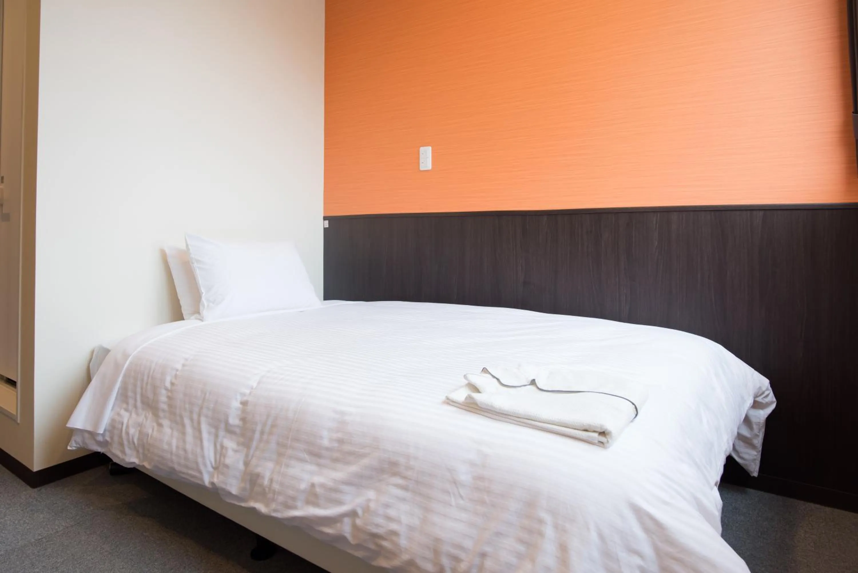 Bed in Crown Hotel Okinawa Annex