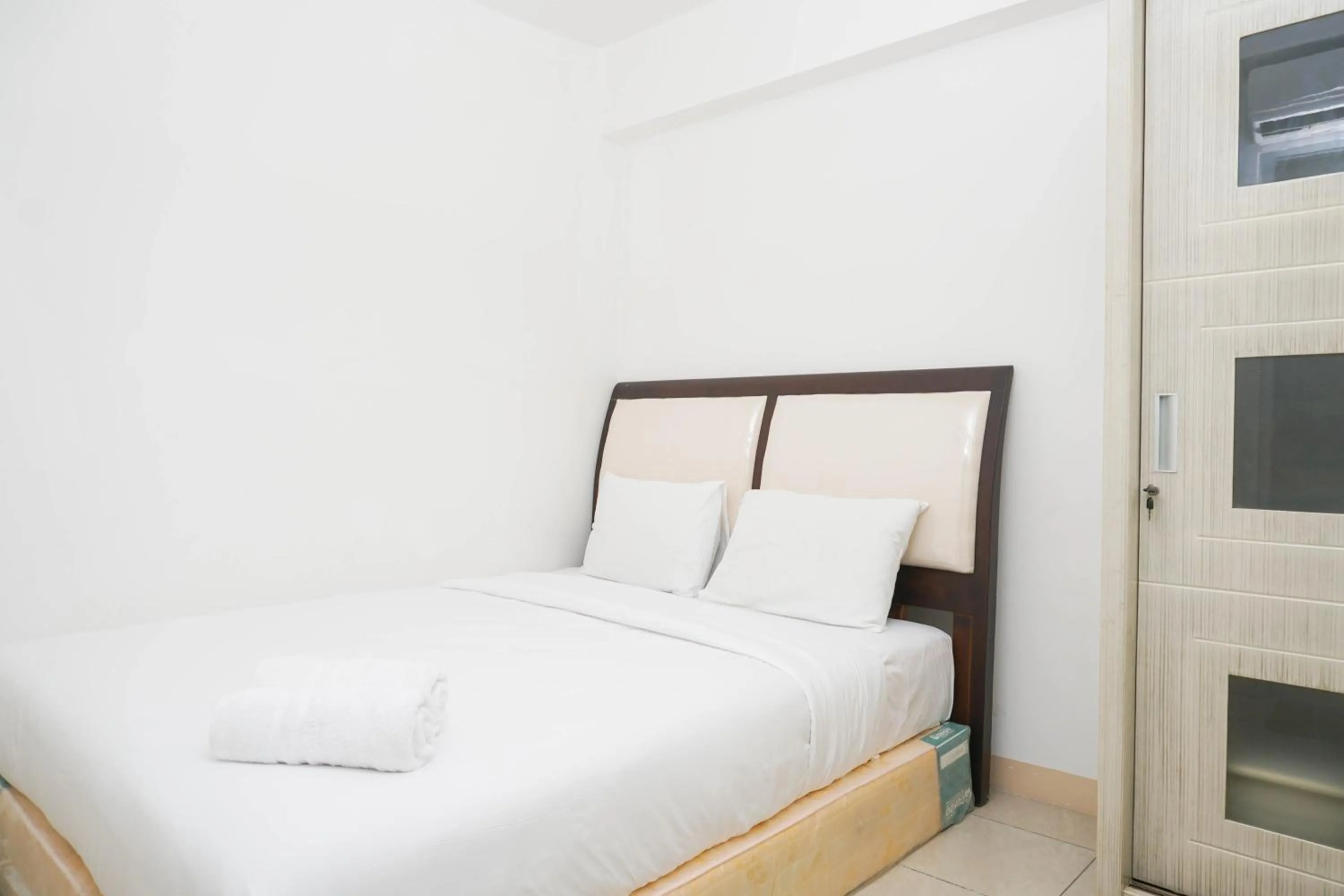 Bed in Spacious 2BR Green Bay Pluit Apartment By Travelio