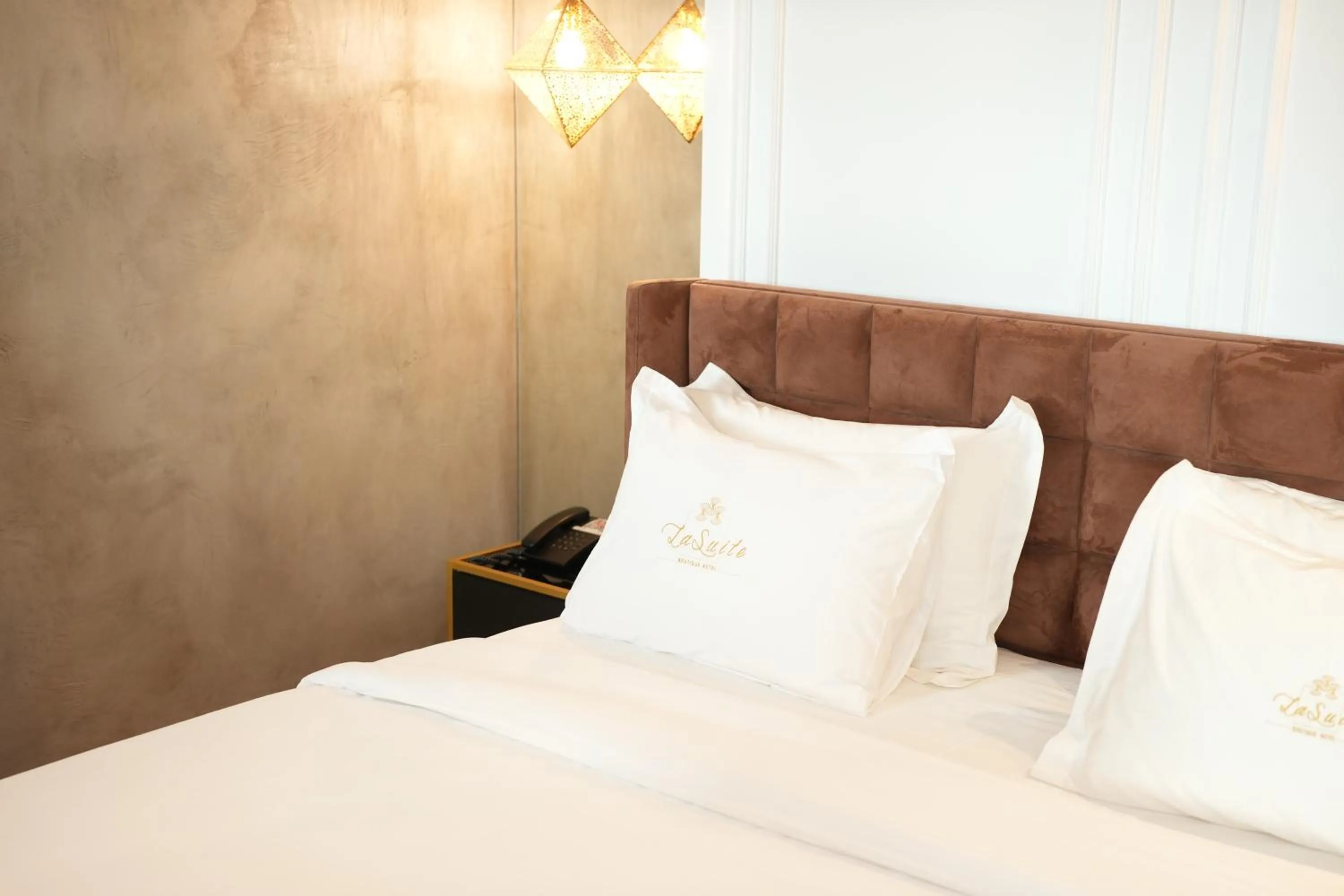 Bed in La Suite Boutique Hotel