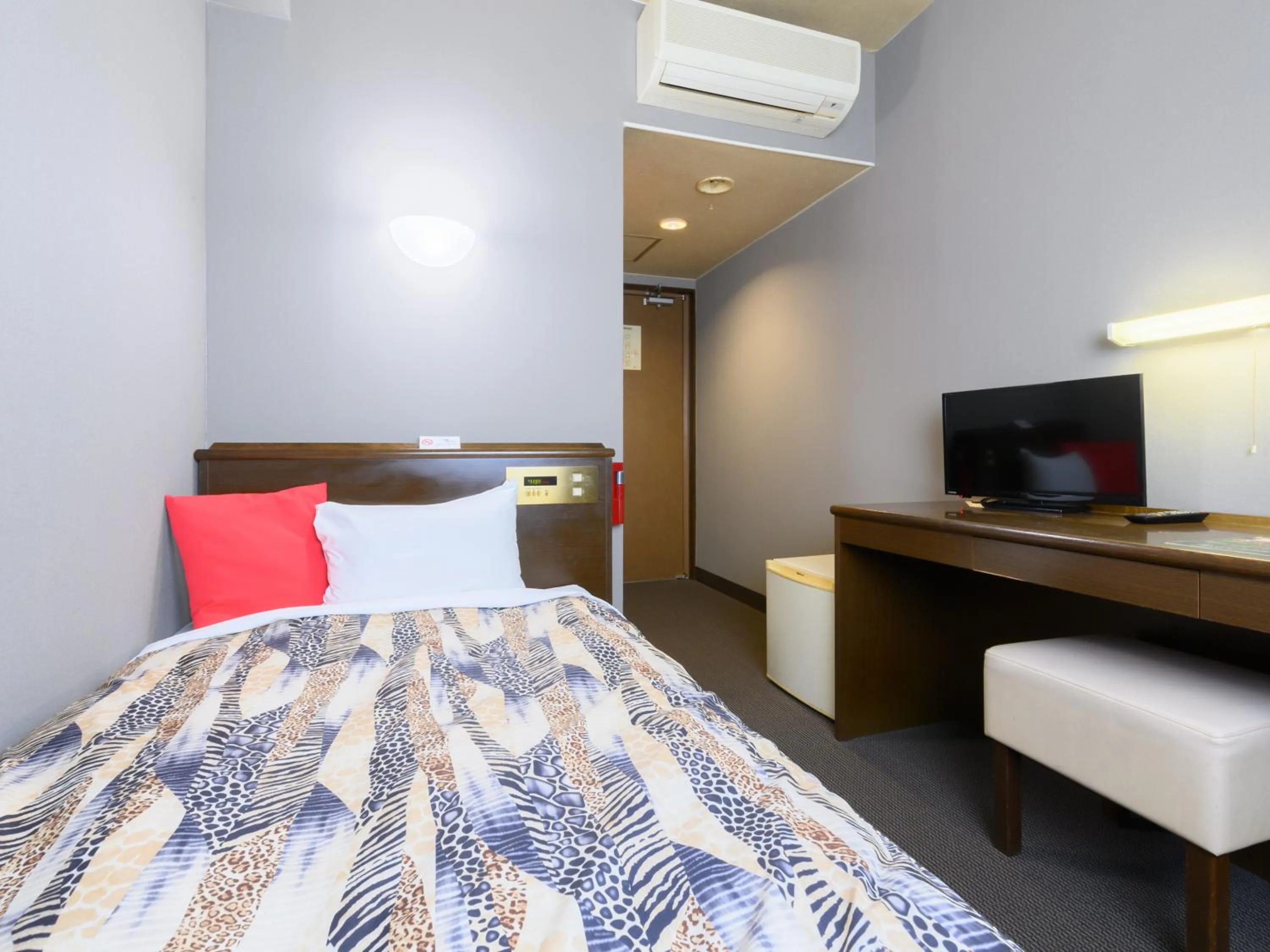 Bed in Tabist IWATA Station Hotel