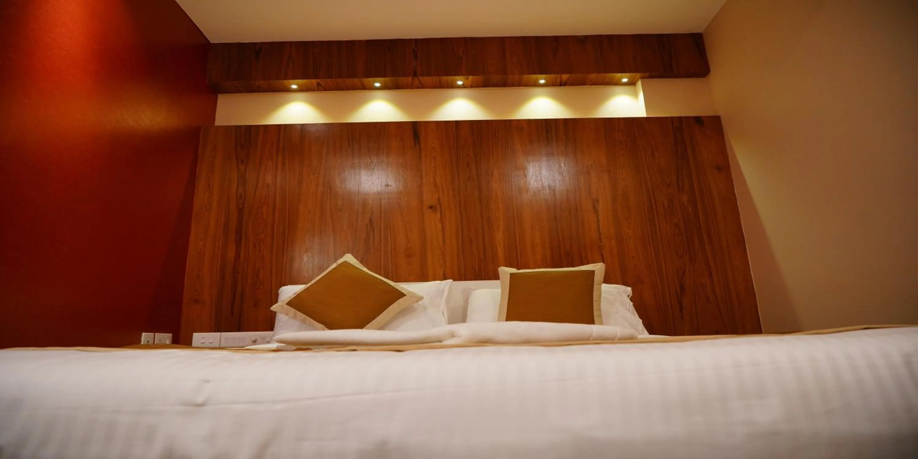 Bed in Nextel Inn, Calicut