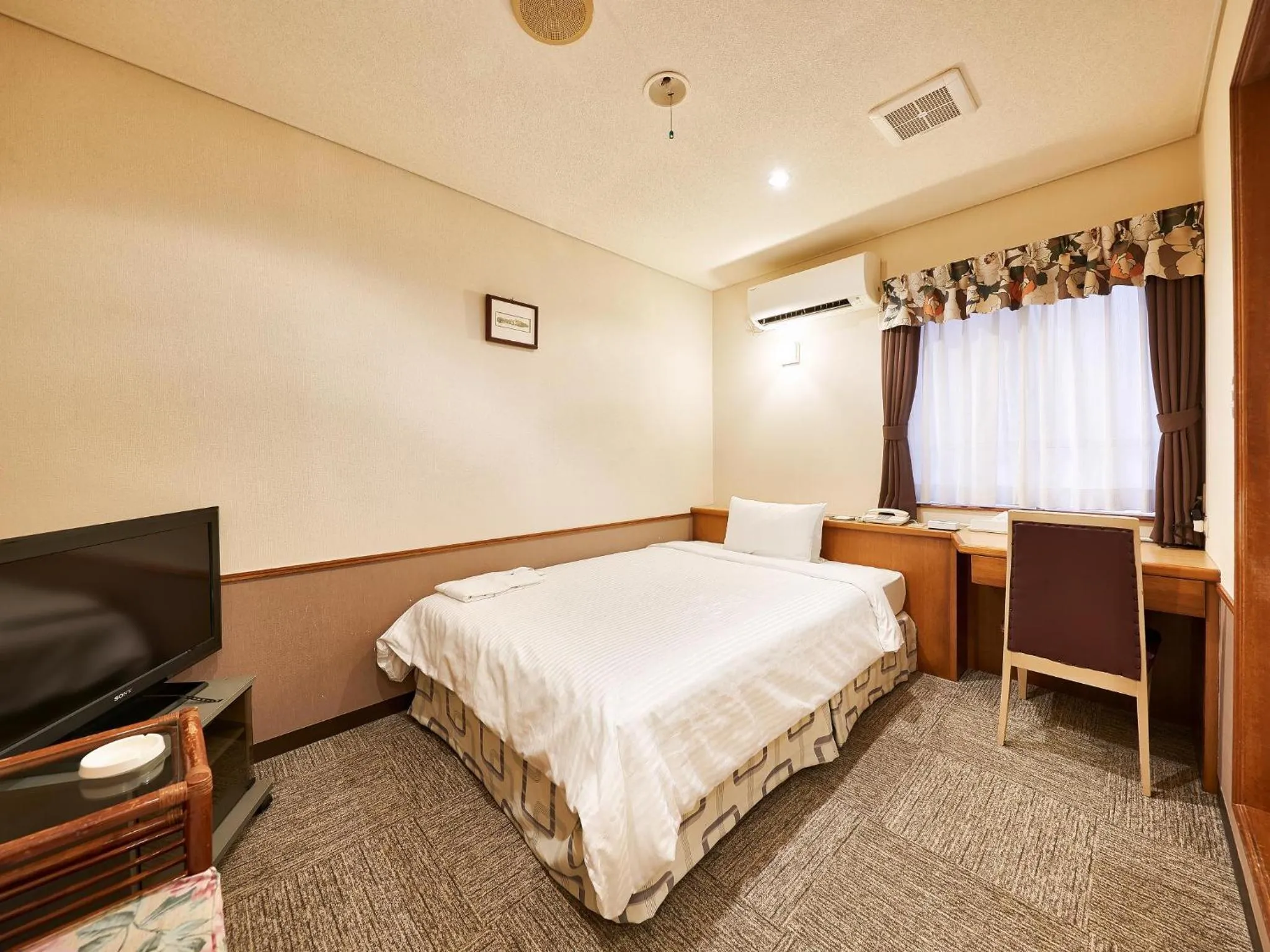 Photo of the whole room, Bed in Crown Hotel Okinawa
