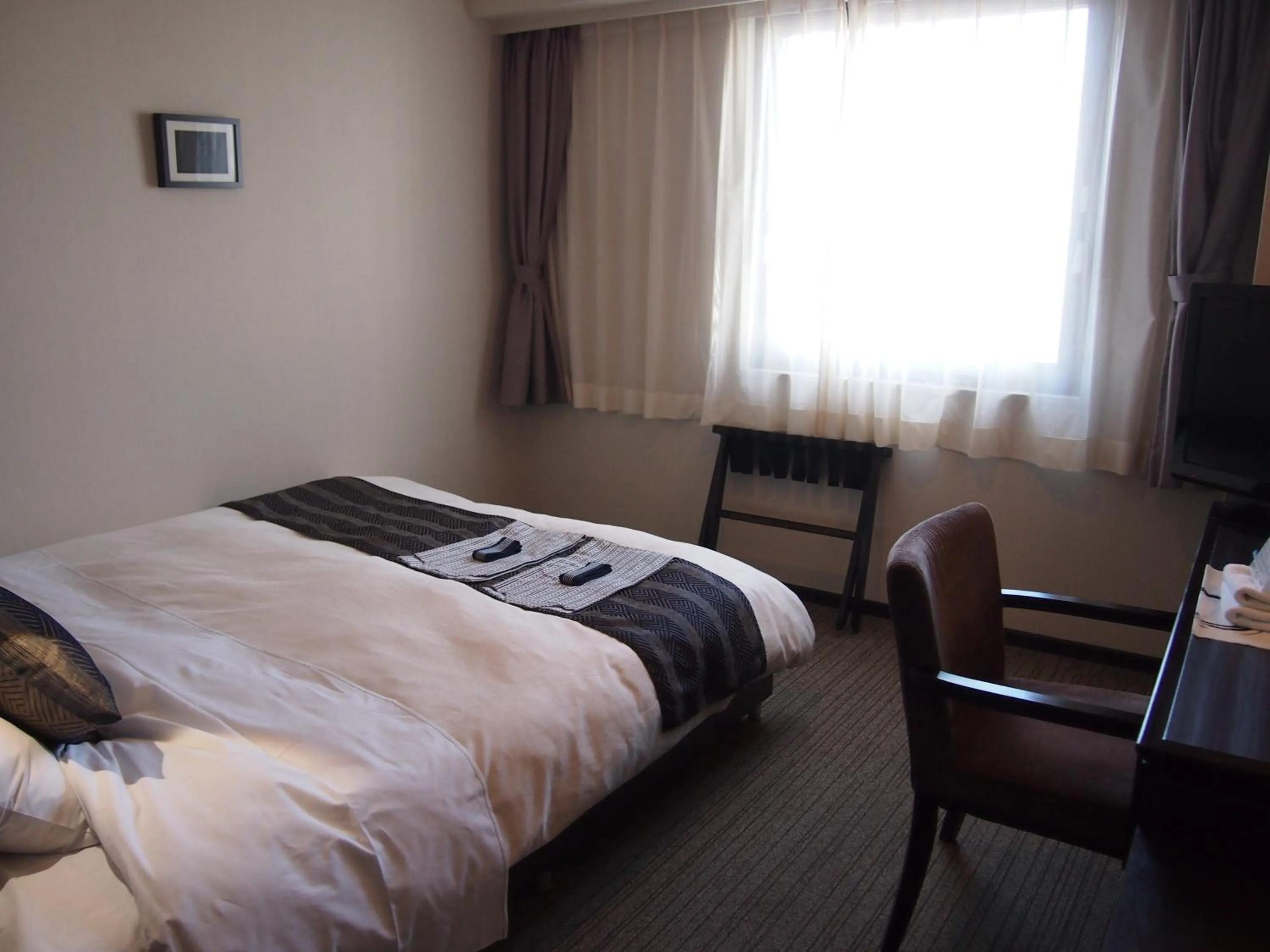 Photo of the whole room, Bed in Silk Inn Kagoshima