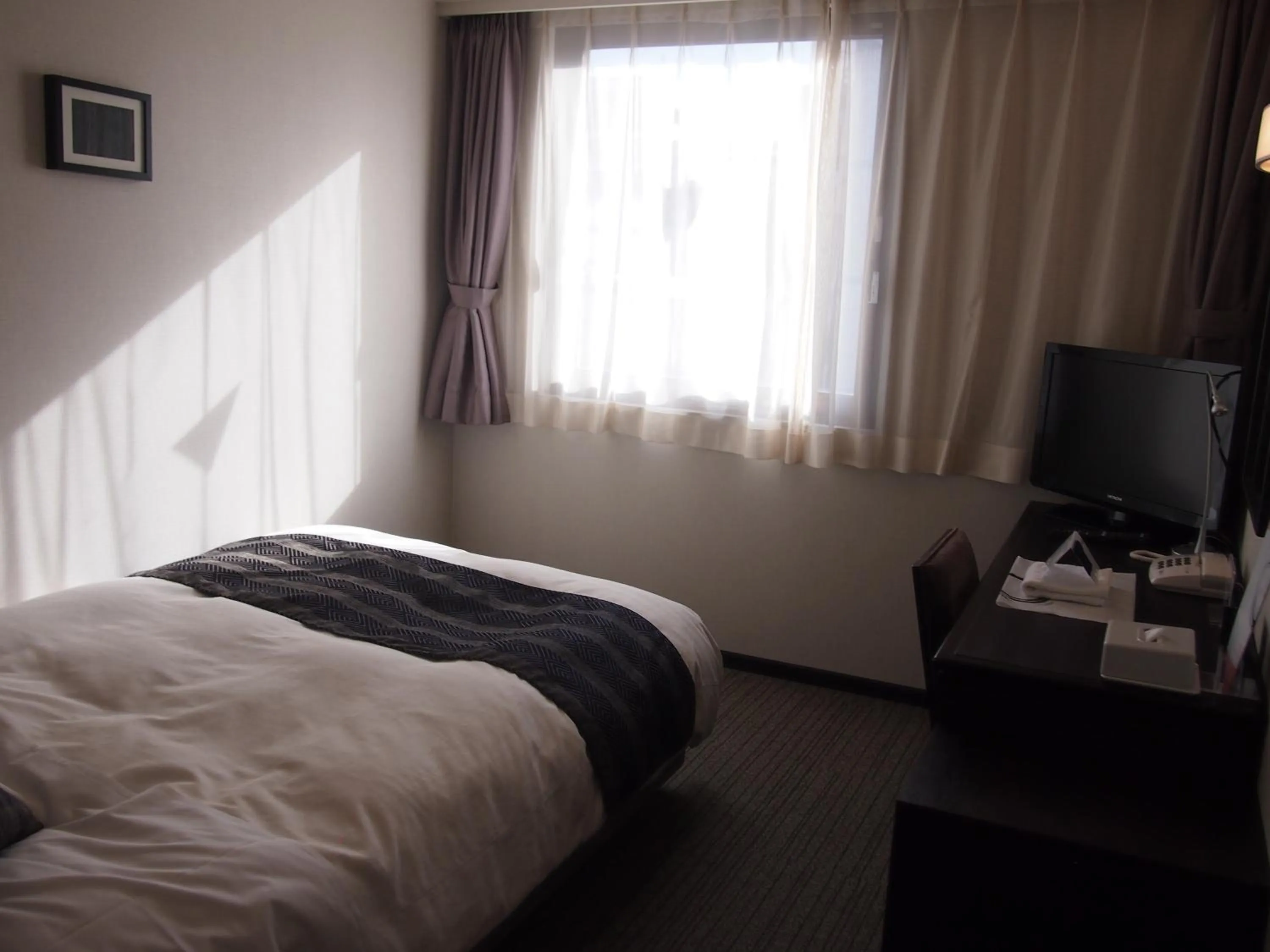 Photo of the whole room, Bed in Silk Inn Kagoshima