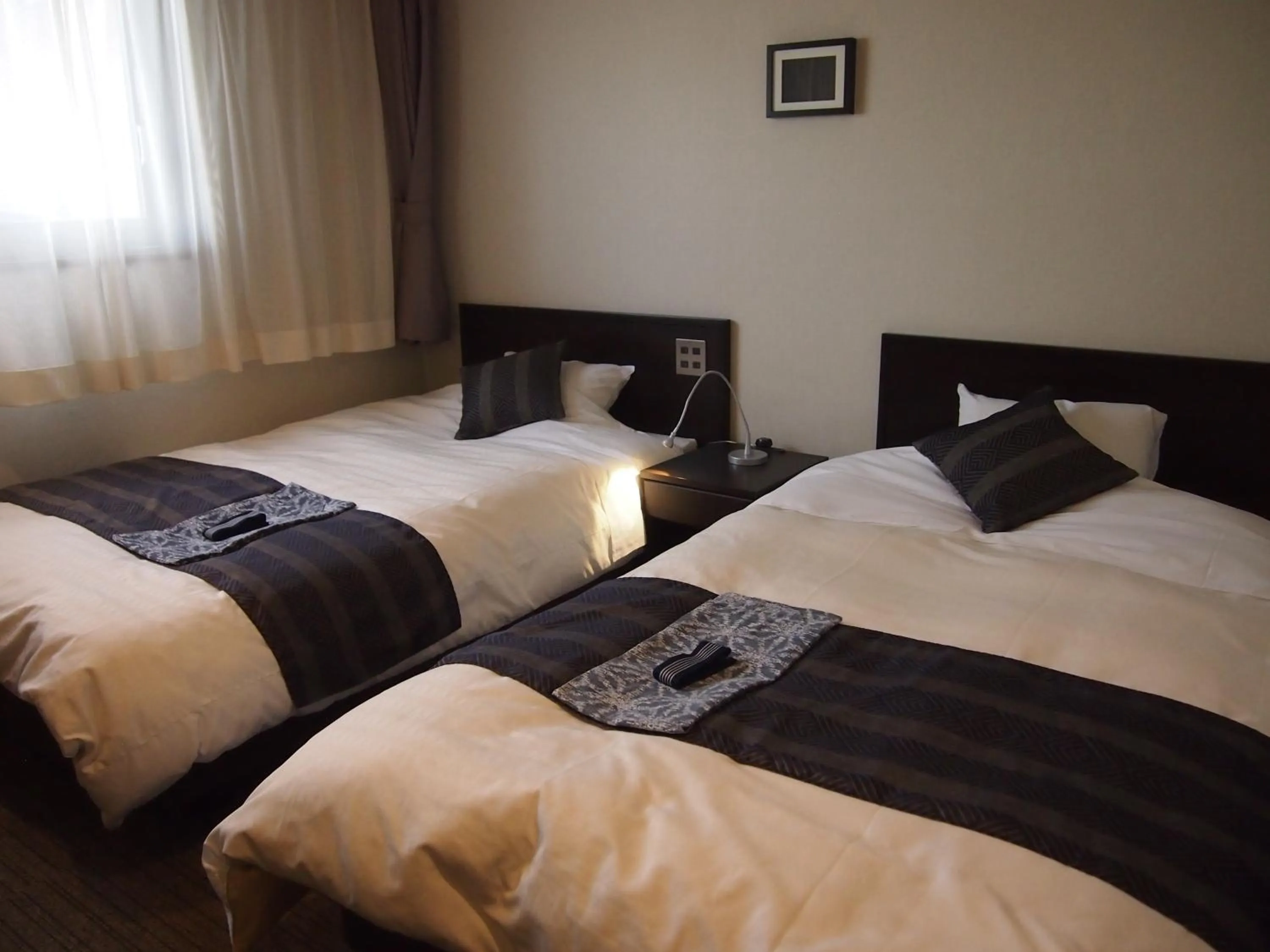 Bed in Silk Inn Kagoshima