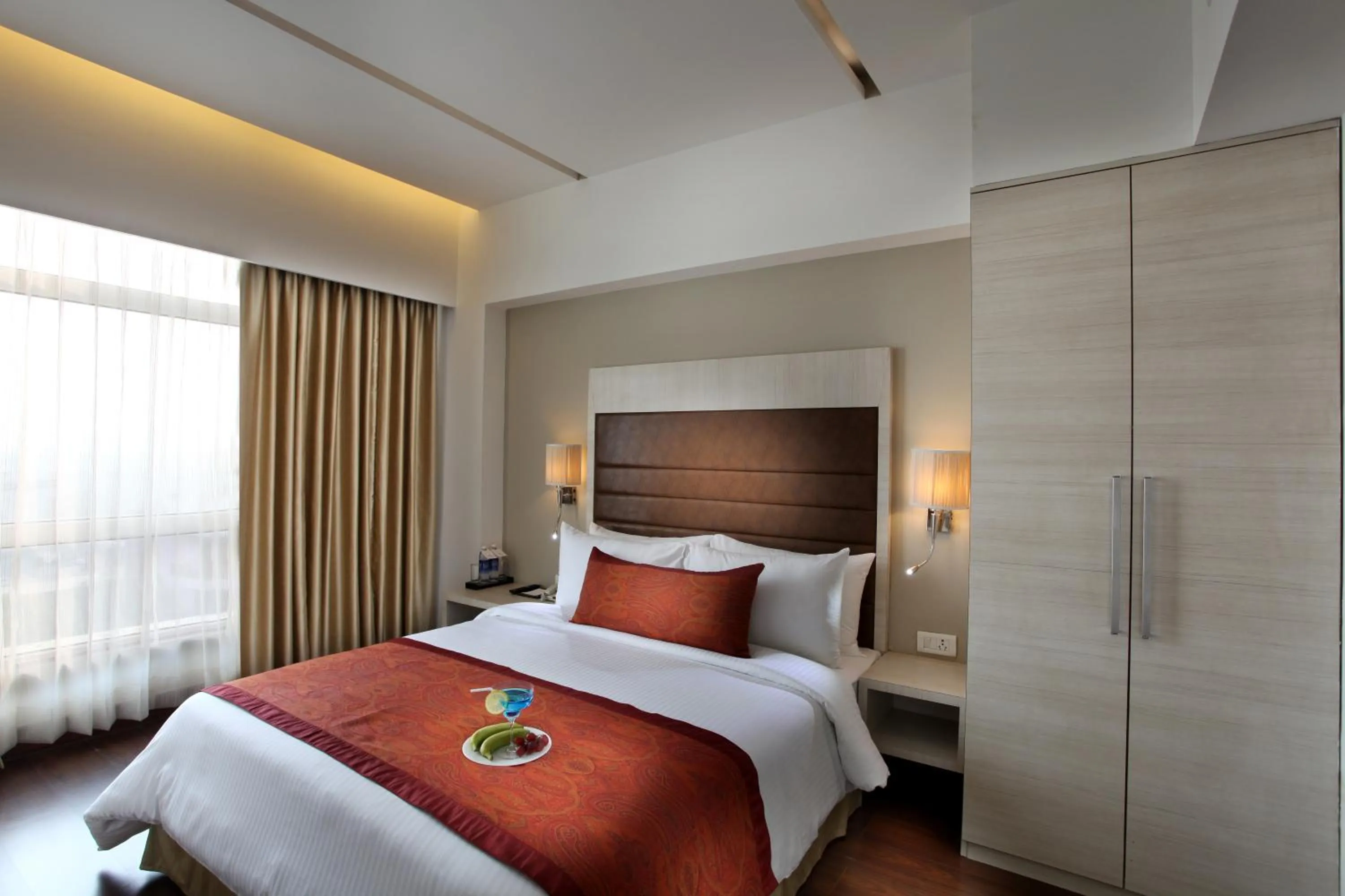 Bed in Mahagun Sarovar Portico Suites