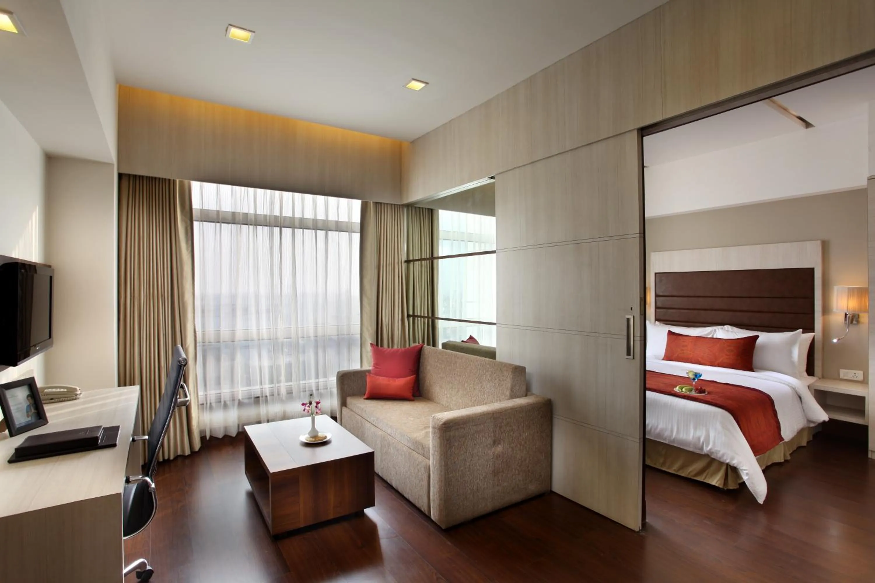 Living room, Bed in Mahagun Sarovar Portico Suites