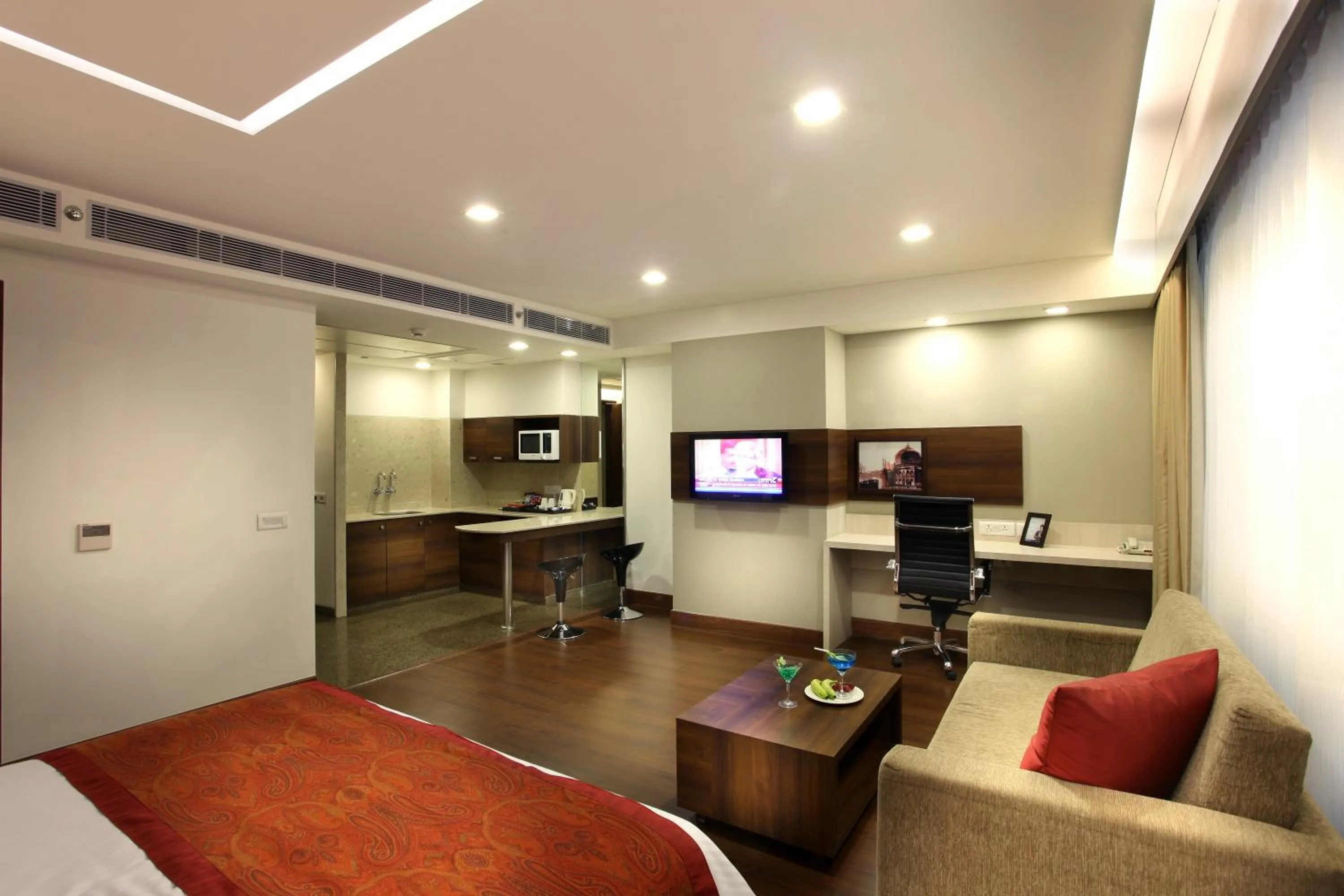 Living room, Bed in Mahagun Sarovar Portico Suites