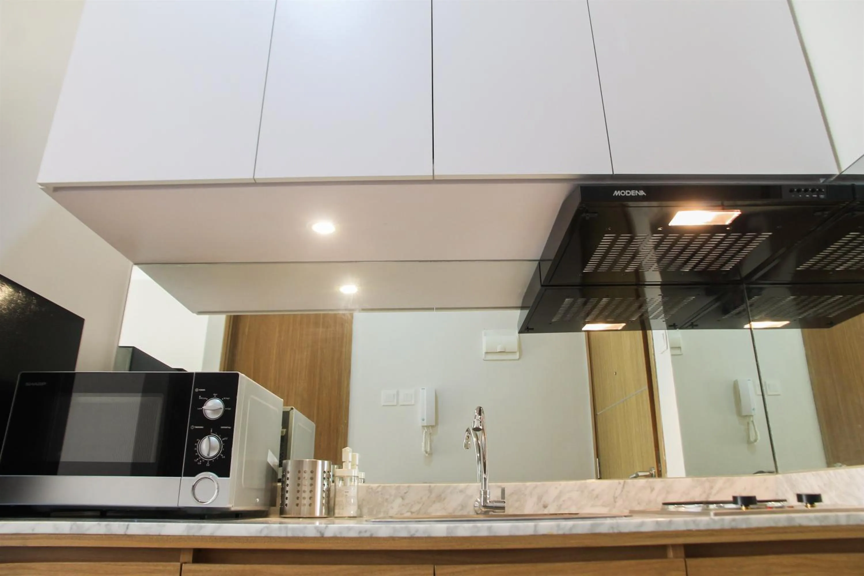 Kitchen or kitchenette in Comfy Studio Room The Oasis Cikarang Apartment By Travelio