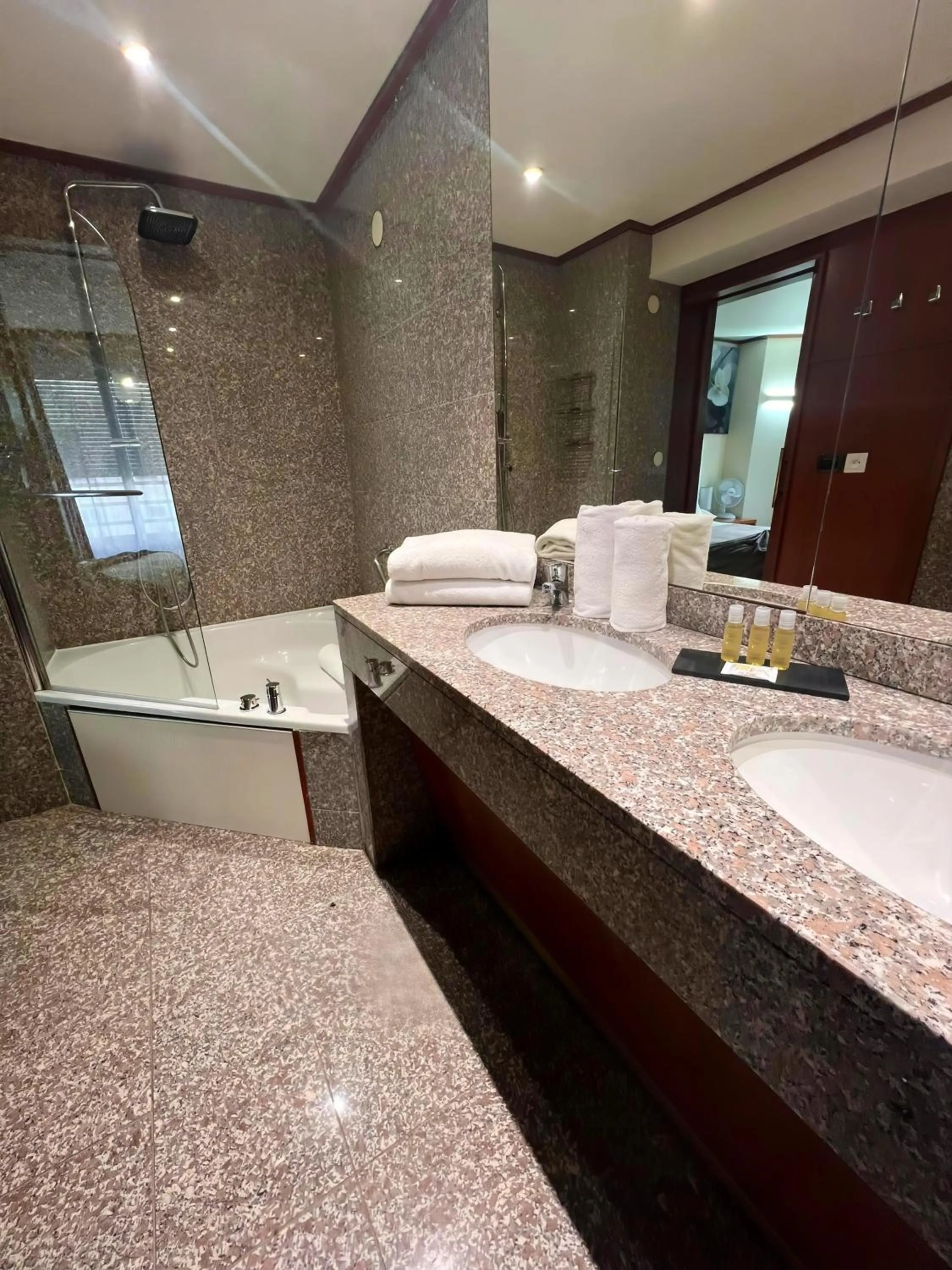 Bathroom in Goldstar Apartments & Suites