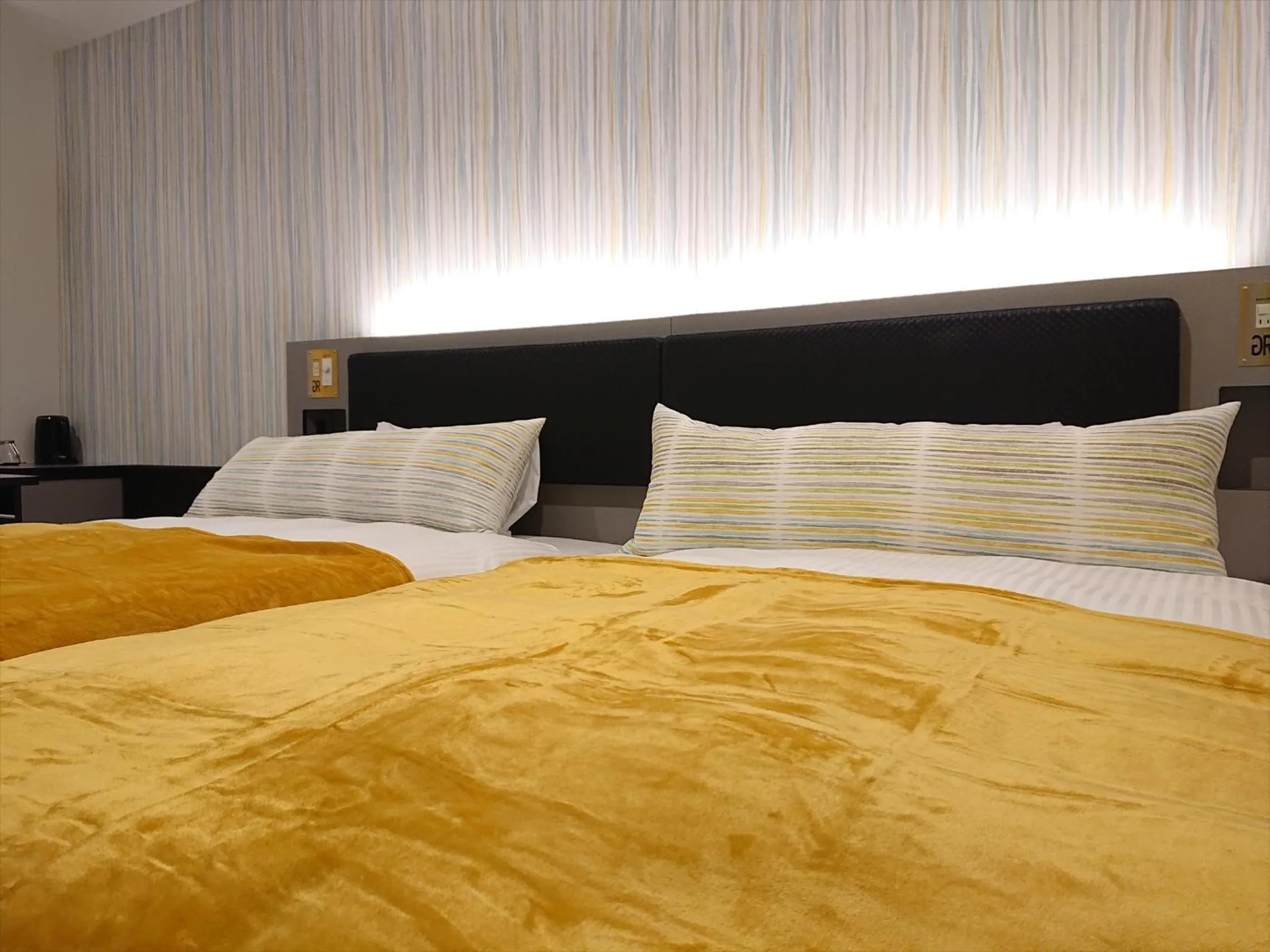 Bed in Green Rich Hotel Okinawa Nago (Artificial hot spring Futamata Yunohana)