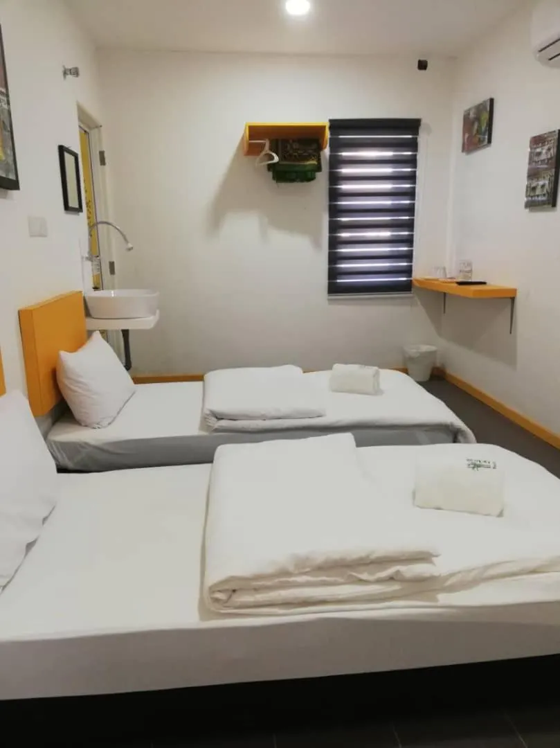 Bed in The Serai Cottage Downtown Hotel