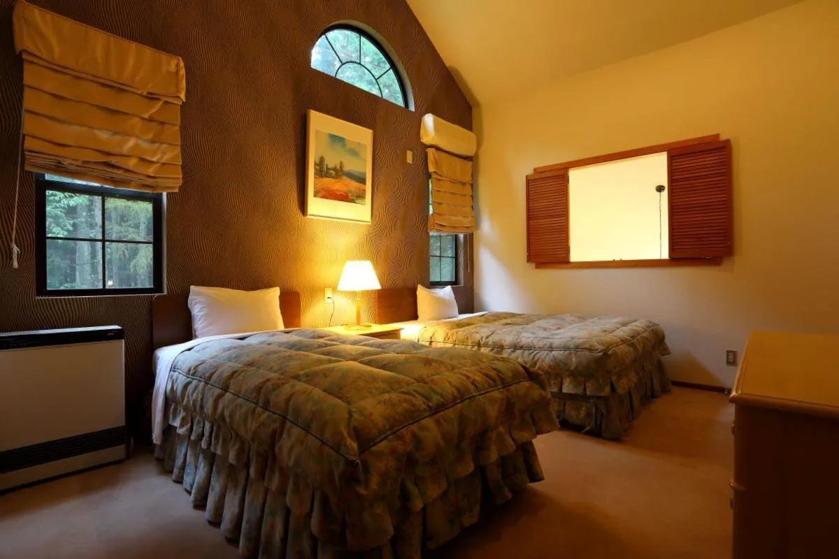 Bed in Hakuba Royal Suites