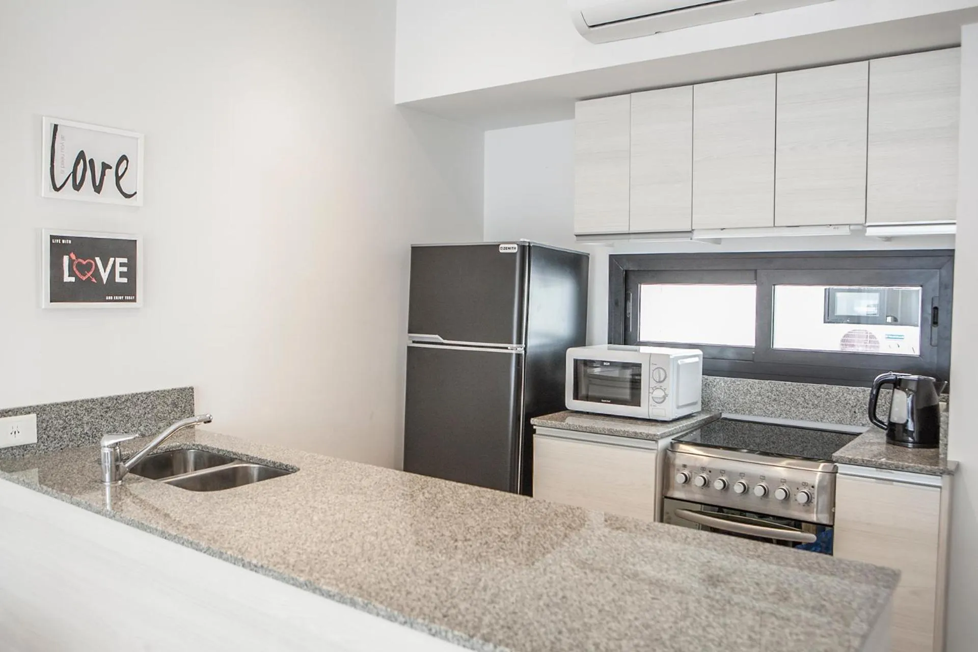 Kitchen or kitchenette in Monroe Suites