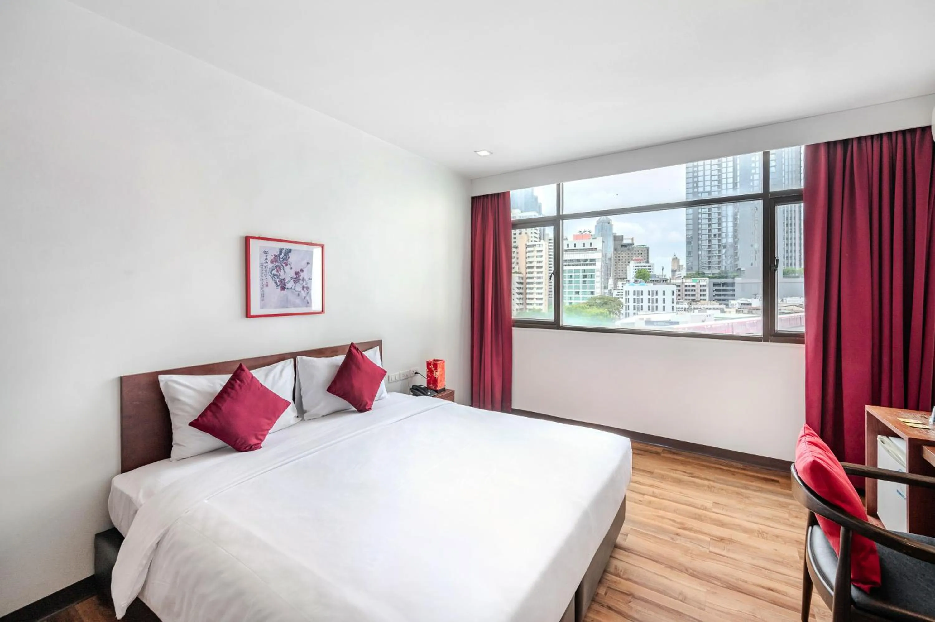 Bed in Ruamchitt Plaza Hotel