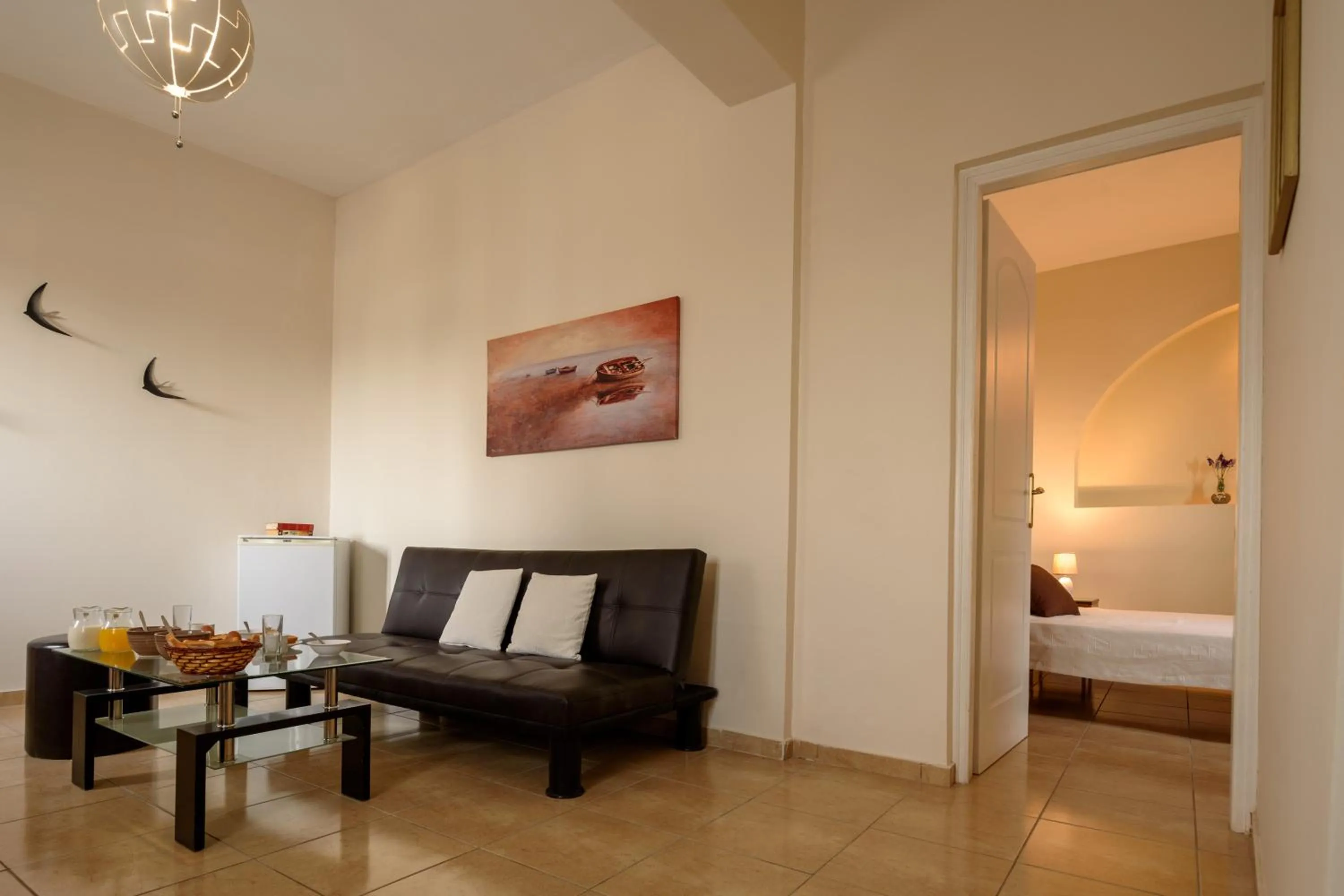 Living room, Bed in Moonlight Apartments & Suites