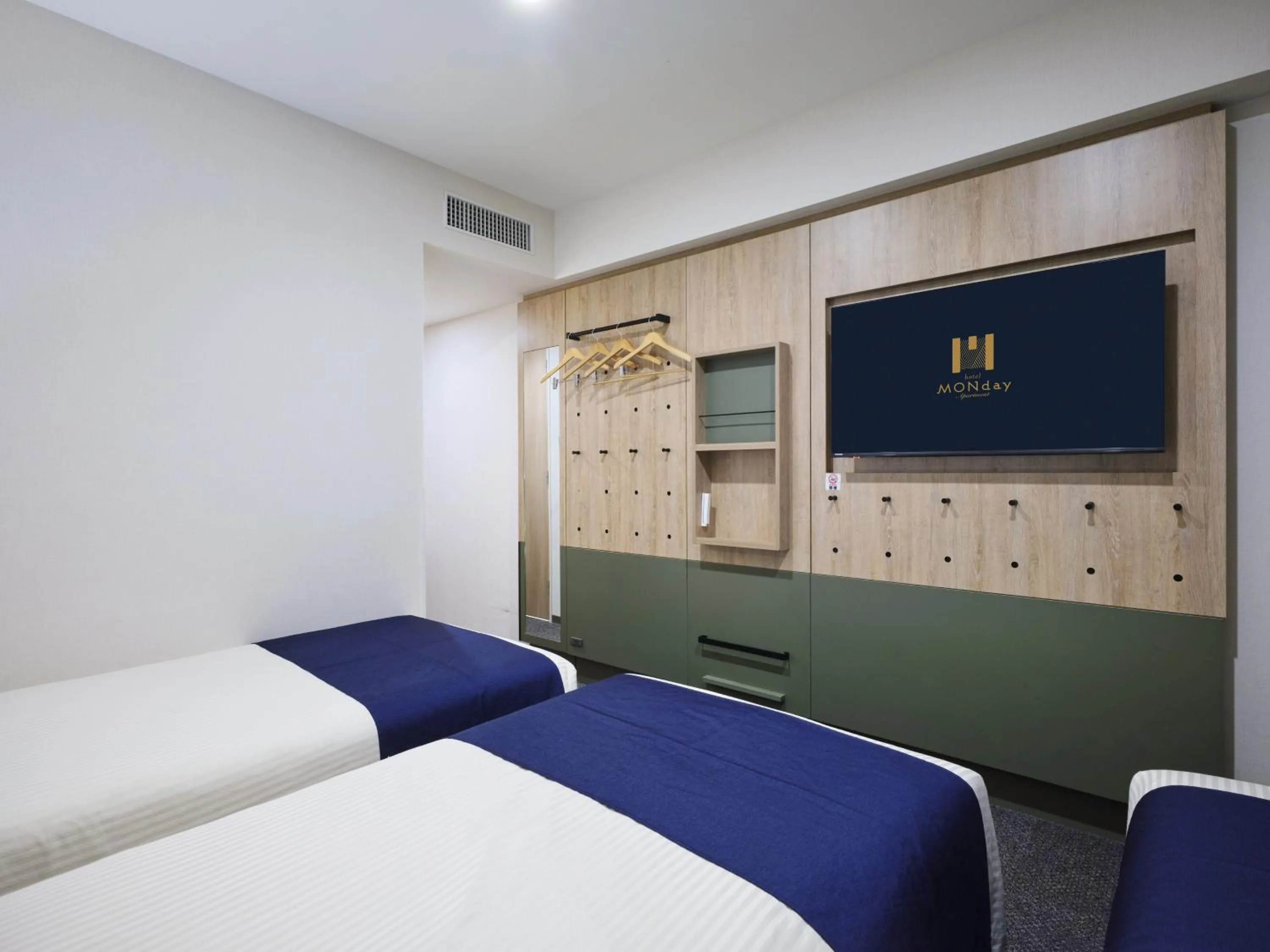 Bed in hotel MONday Premium Ueno Okachimachi