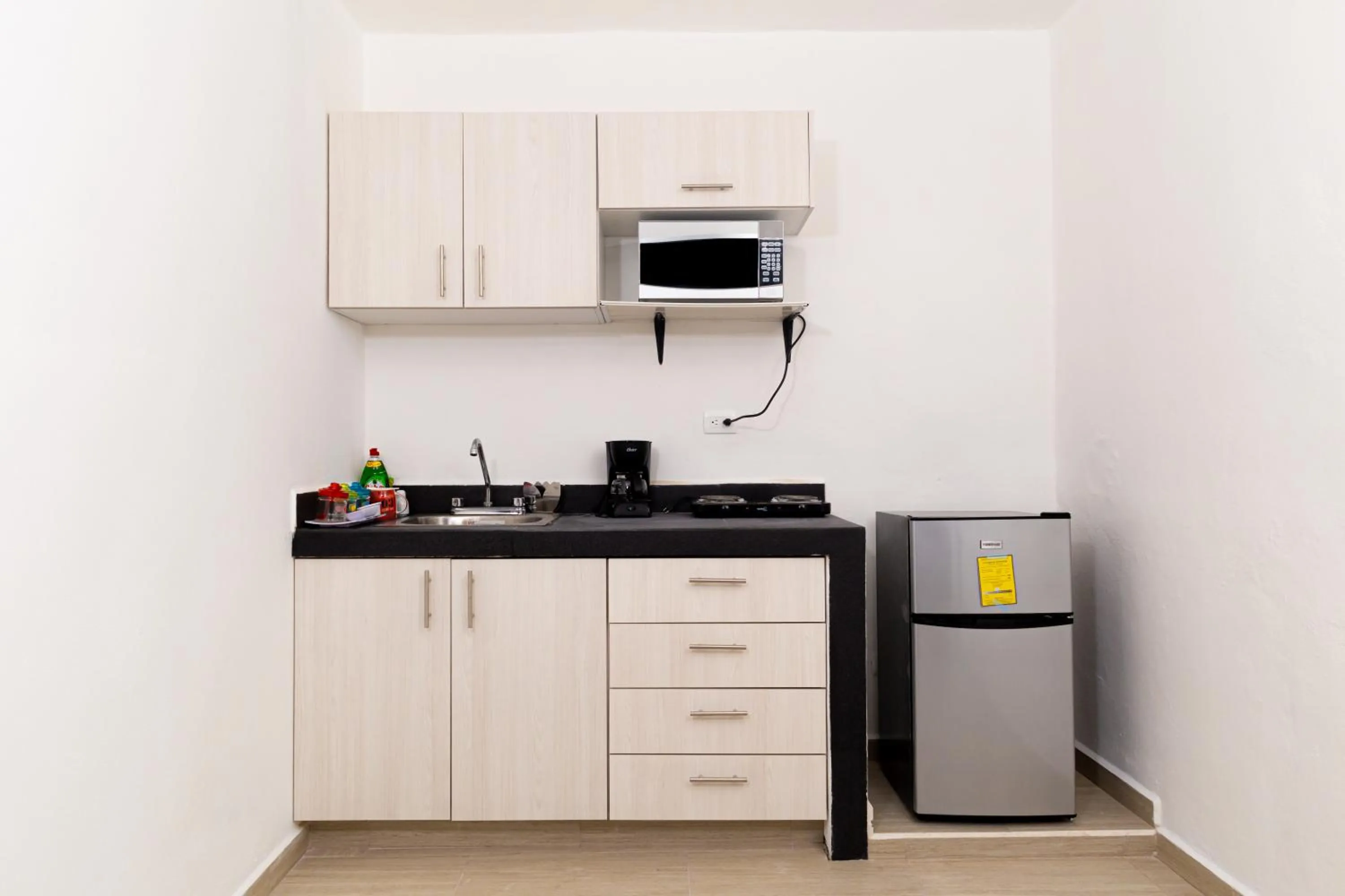 Kitchen or kitchenette in Santa Fe Studios And Suites