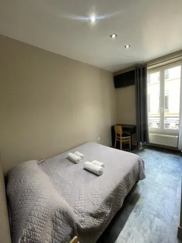 Bed in Hôtel de l'Aveyron