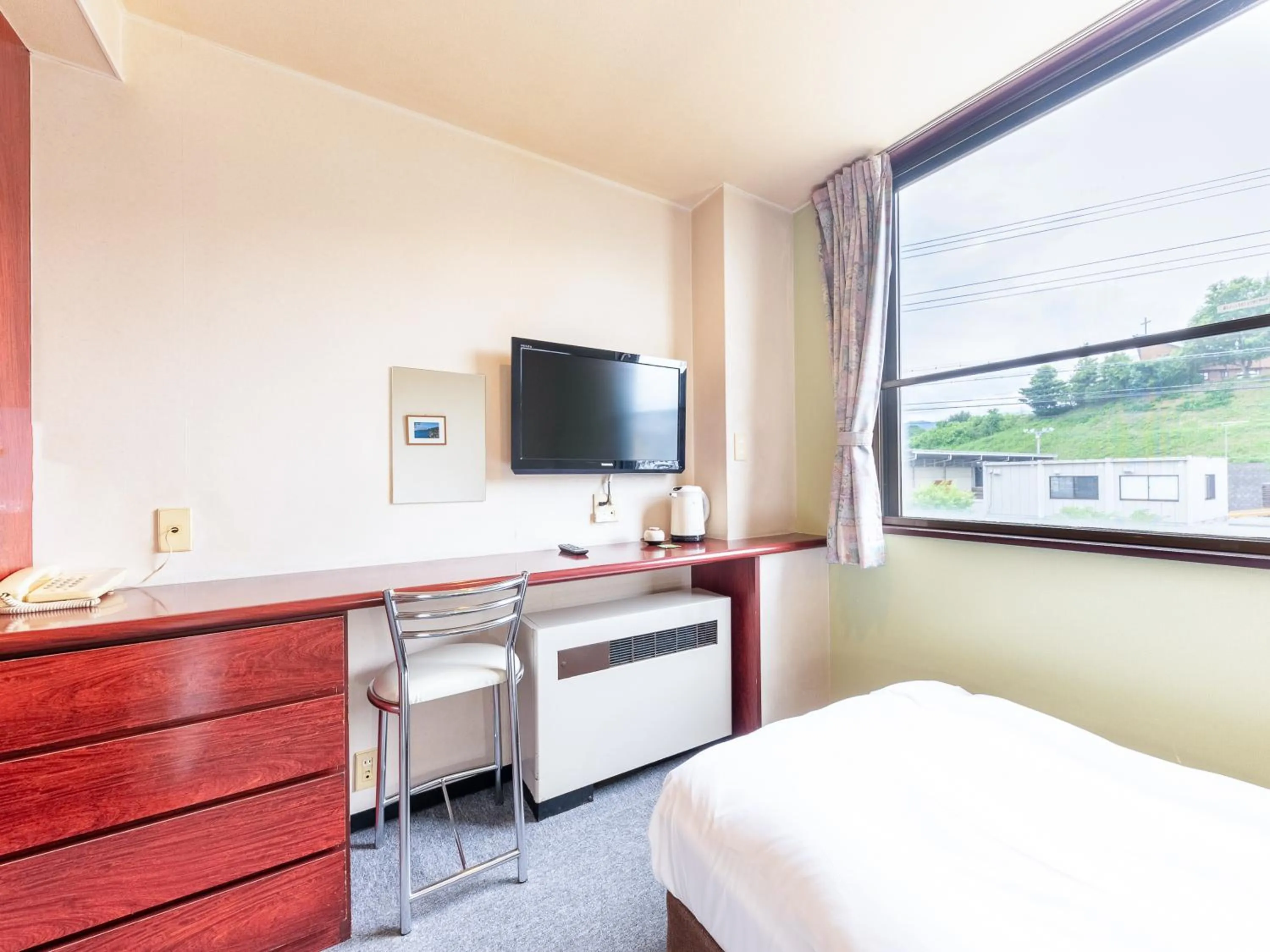 Bed in Tabist Travel Inn Shinshu Nakano