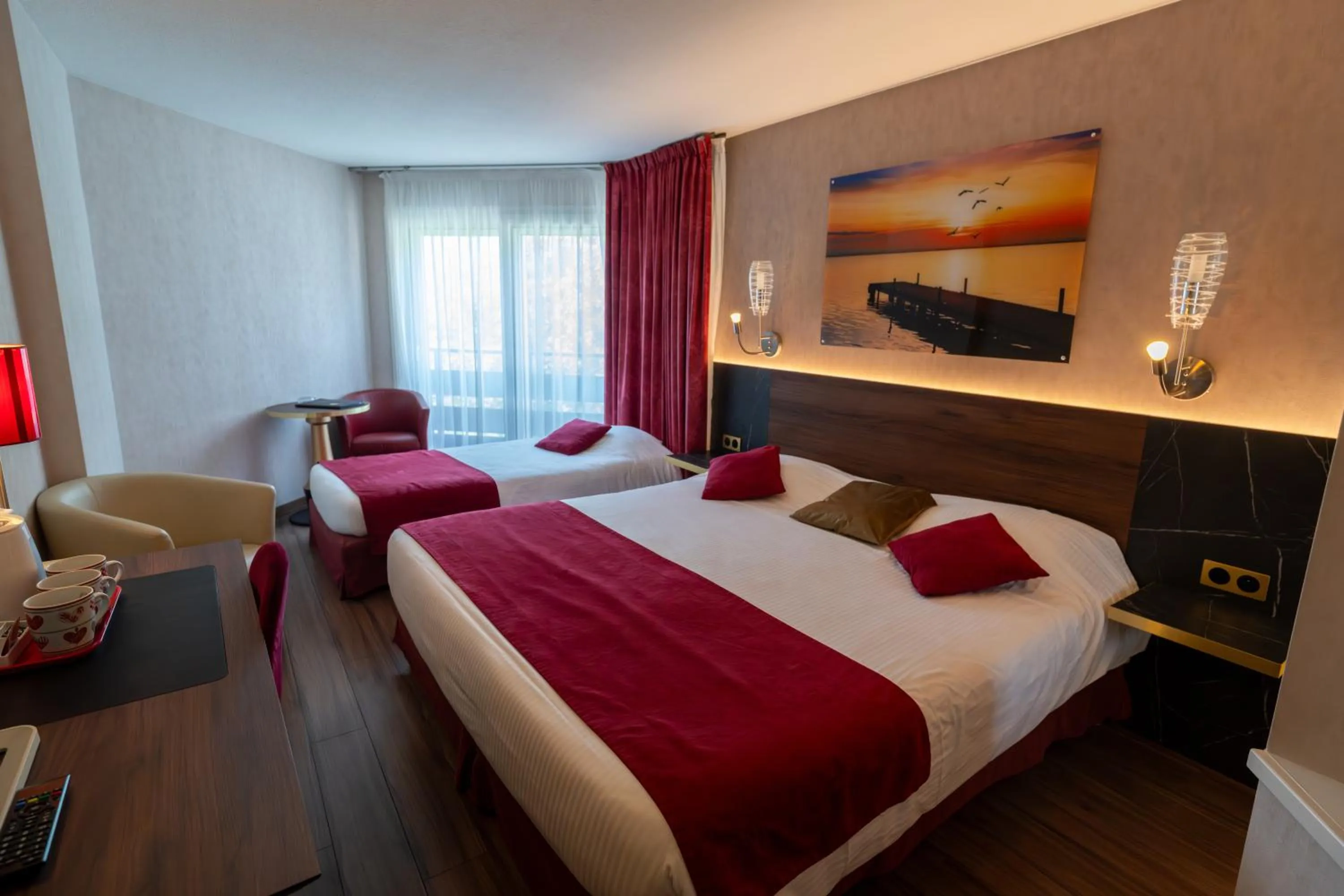 Bed in Logis Hotel Arc En Ciel