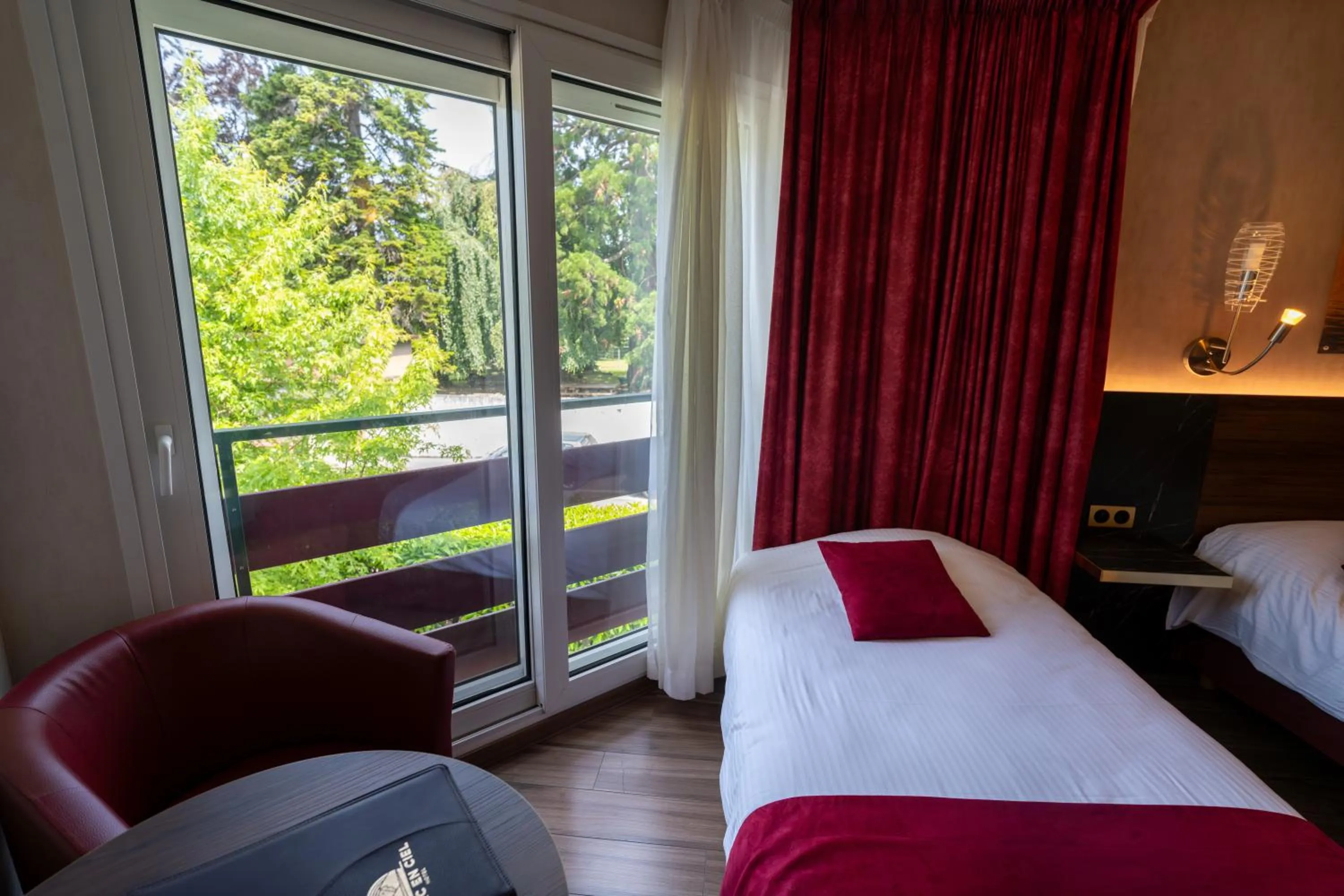 Bed in Logis Hotel Arc En Ciel