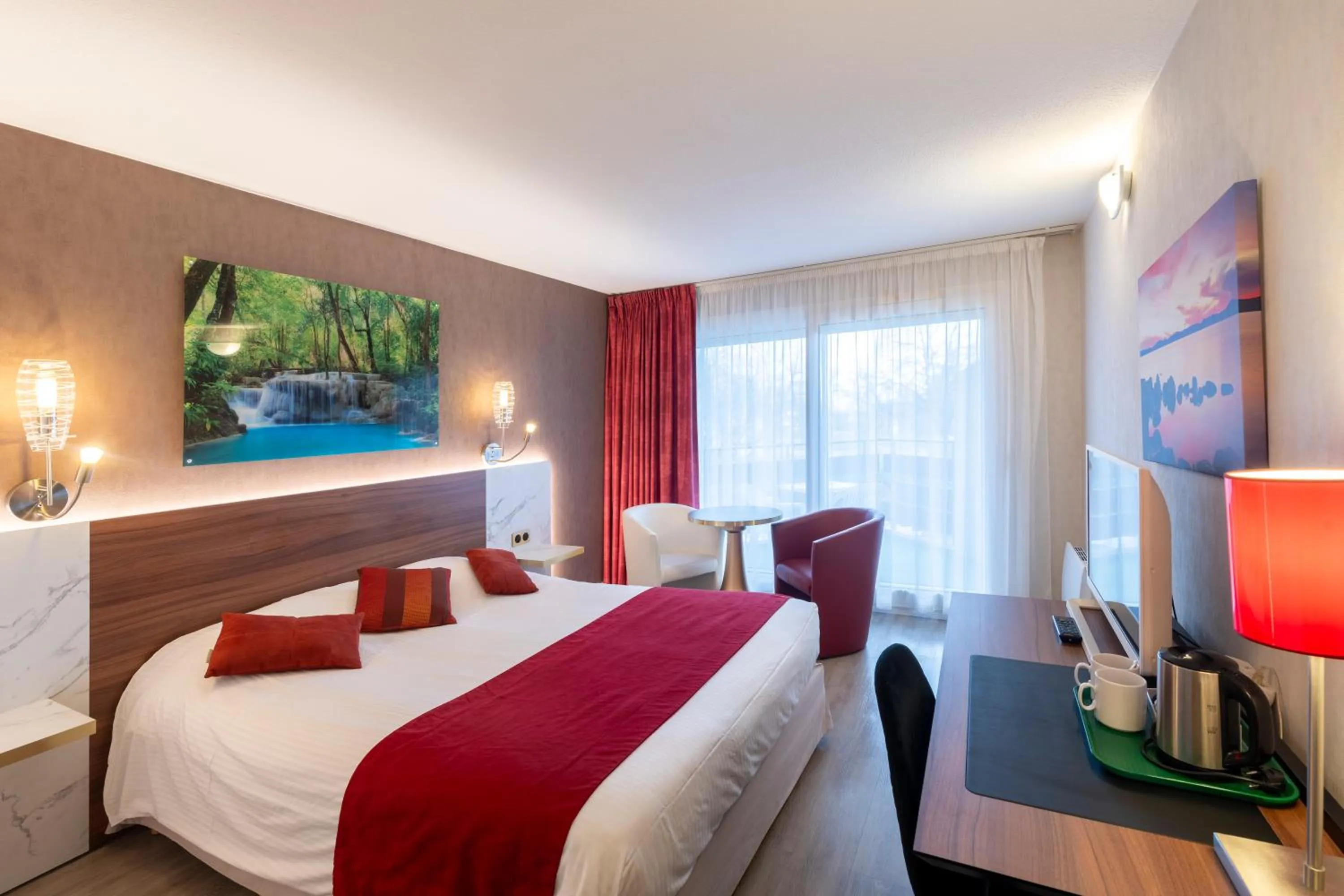 Bed in Logis Hotel Arc En Ciel