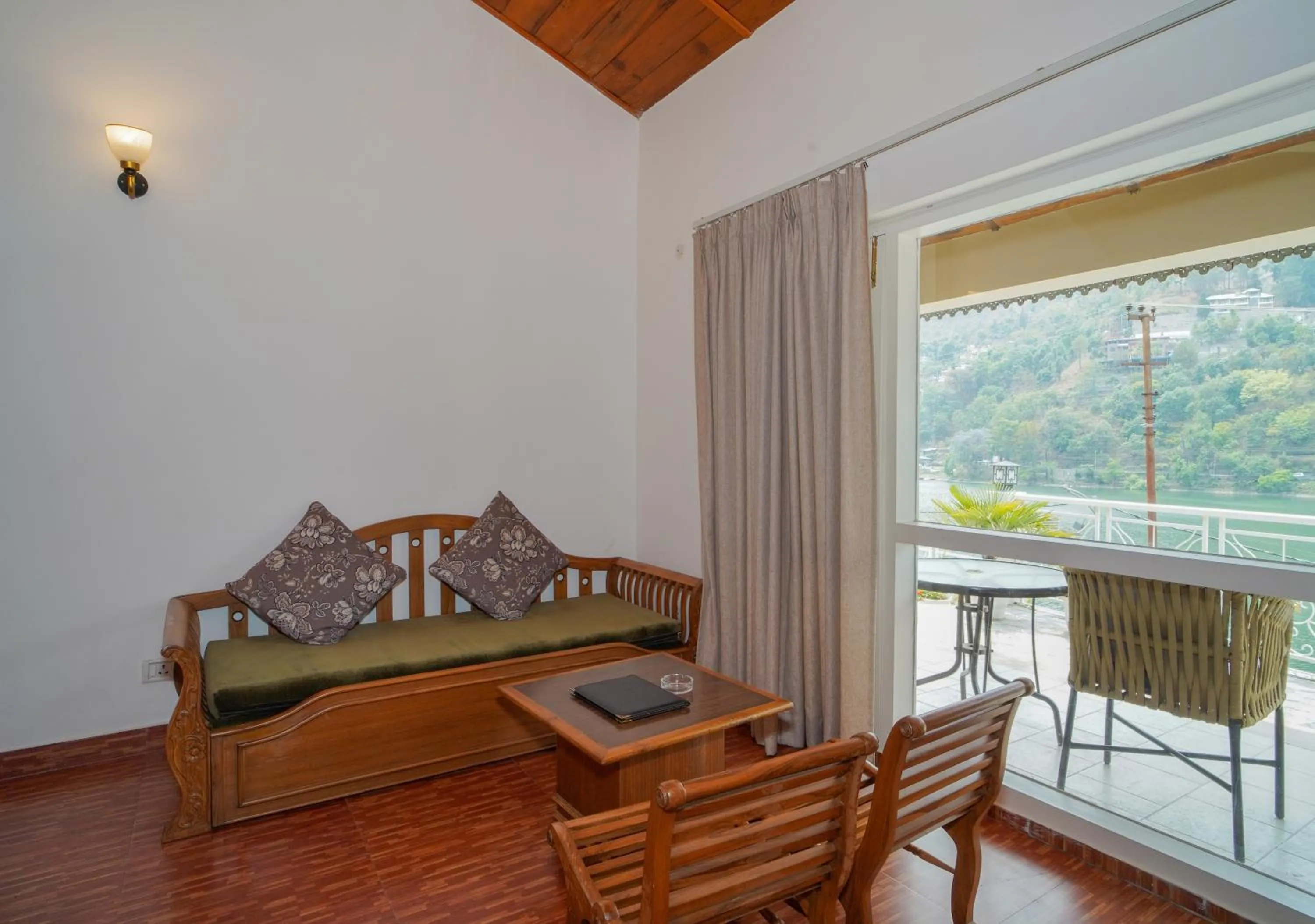 Seating area, Bed in Neelesh Inn- A Luxury Lake View Hotel- 20 kms from Nainital