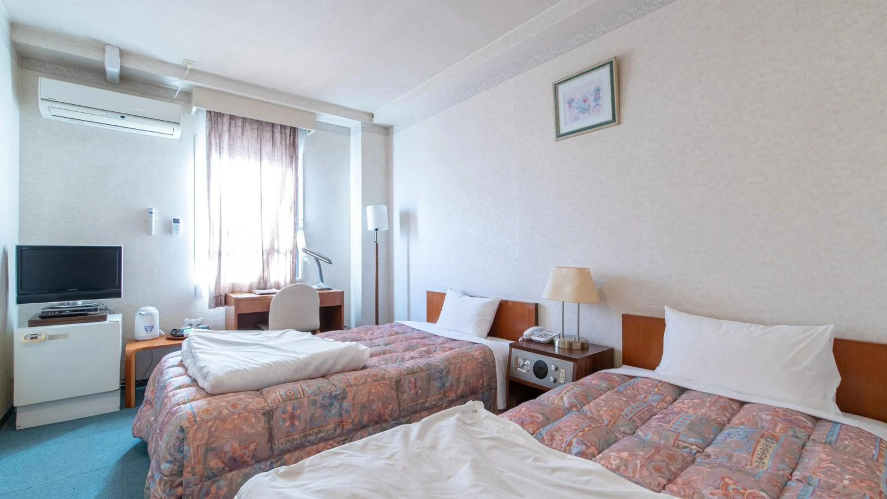 Bed in Aqua Garden Hotel Fukumaru